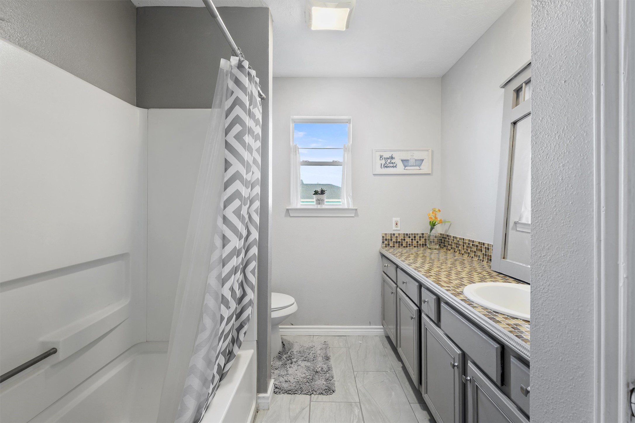 Secondary bathroom features a
tub/shower combo and long vanity
with plenty of counter space.