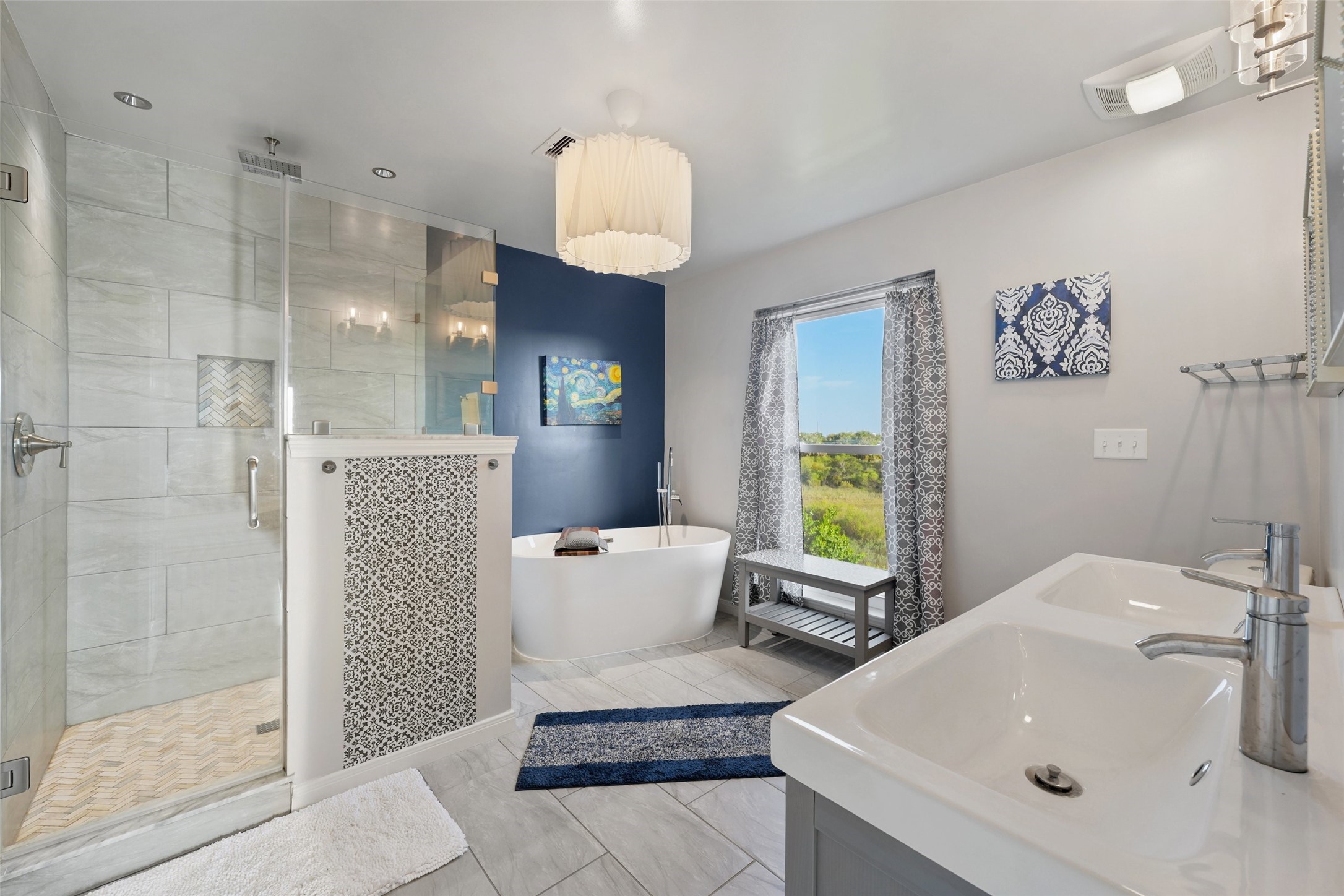 The primary bathroom features tile floors, dual sinks, custom paint, spacious walk-in shower, and separate tub.