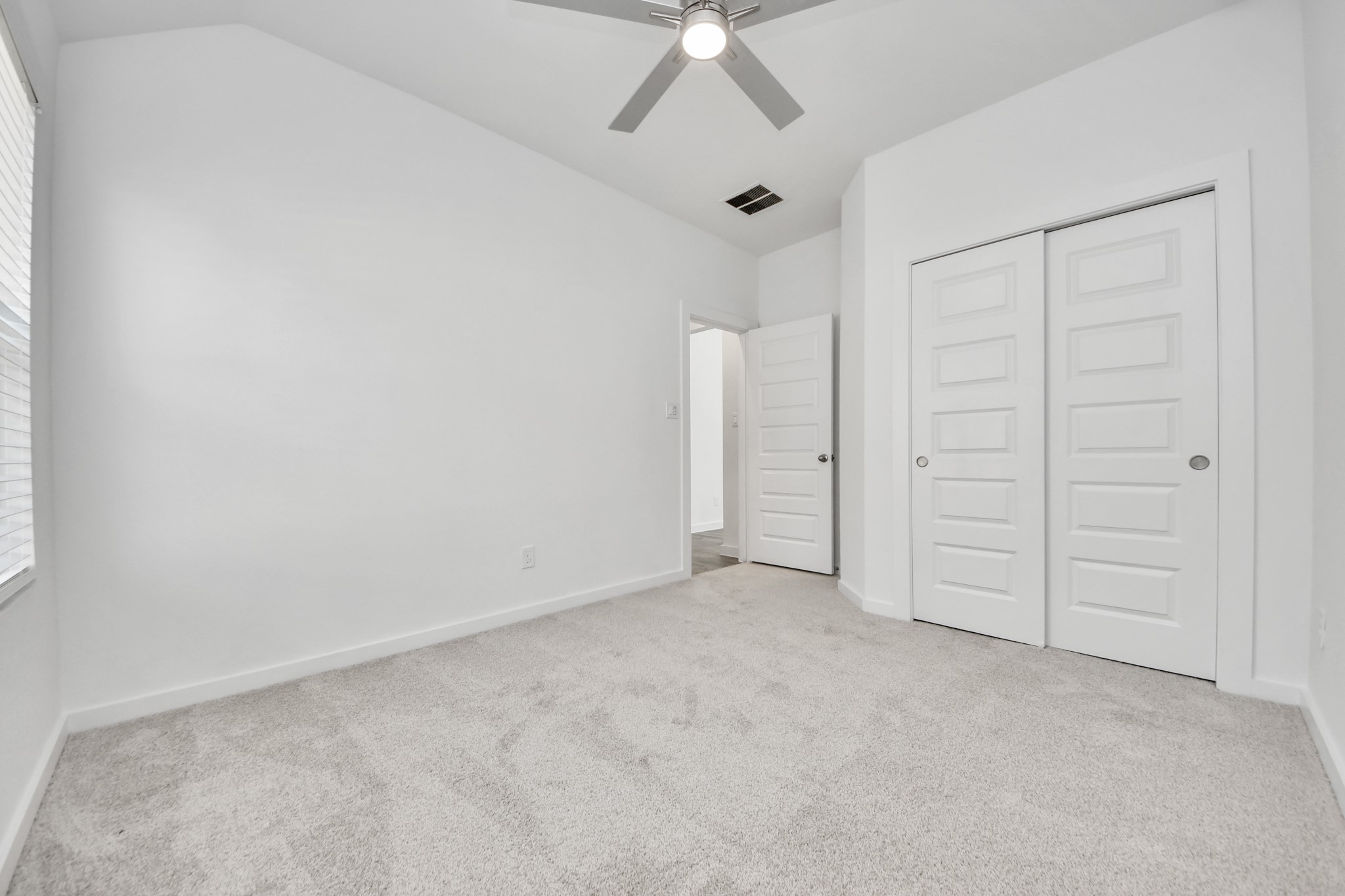 Generously sized secondary bedrooms featuring spacious closets, soft and inviting carpeting underfoot, large windows allowing plenty of natural light, and the added touch of privacy blinds for your personal retreat. Sample photo of completed home with similar floor plan. Actual colors and selections may vary.