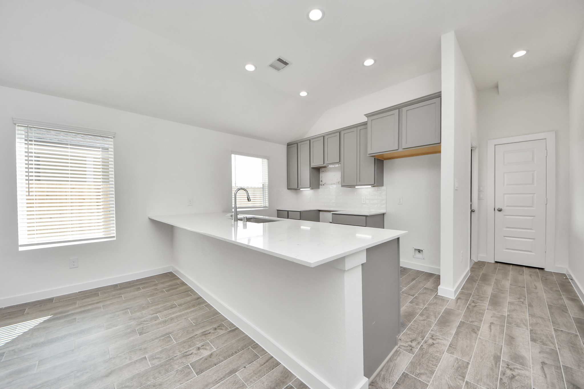 The kitchen is a culinary haven, featuring granite countertops, a tile backsplash, stainless steel appliances, 42 upper cabinets, and undercabinet lighting. Sample photo of completed home with similar floor plan. Actual colors and selections may vary.