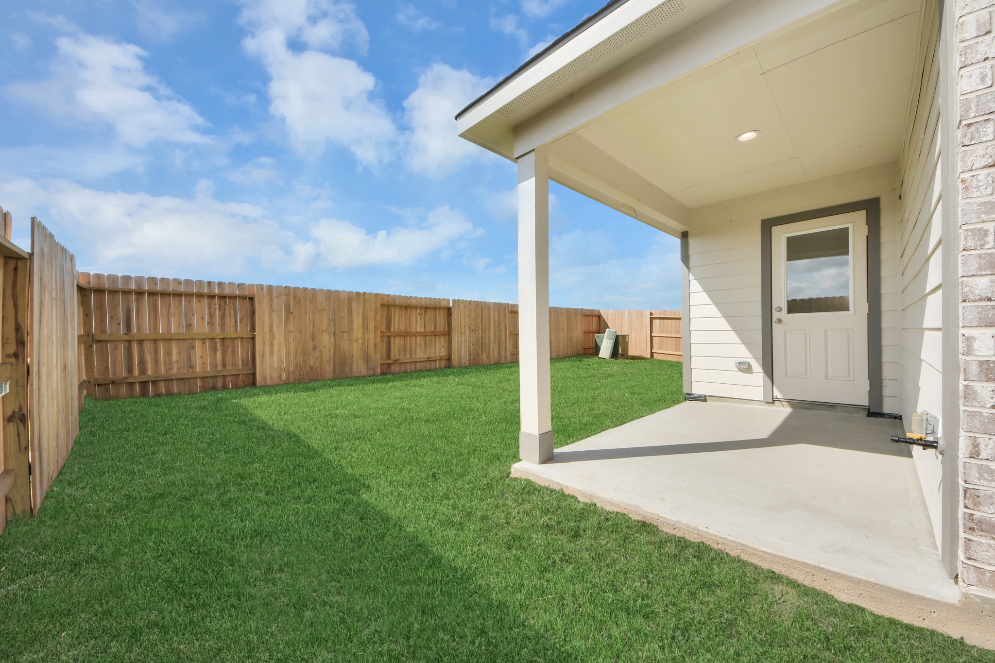 Come and see this spacious backyard with its beautiful covered patio. There is plenty of room for the kids to play and adults to relax. Perfect for your outdoor living space, patio furniture, bbq pit, and so much more. The possibilities are endless! Sample photo of completed home with similar floor plan. Actual colors and selections may vary.