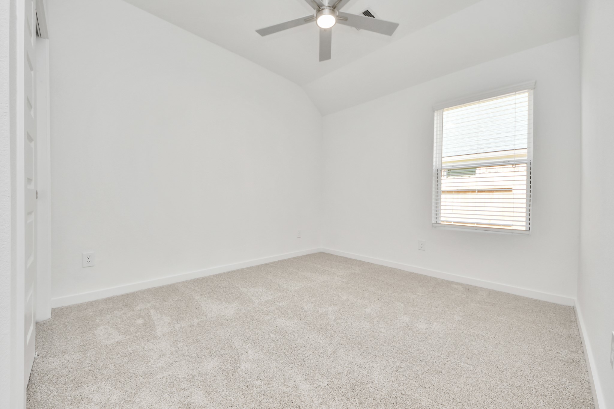 Secondary bedroom features plush carpeting, large windows that let in plenty of natural light, bright paint, and spacious closets. Sample photo of completed home with similar floor plan. Actual colors and selections may vary.