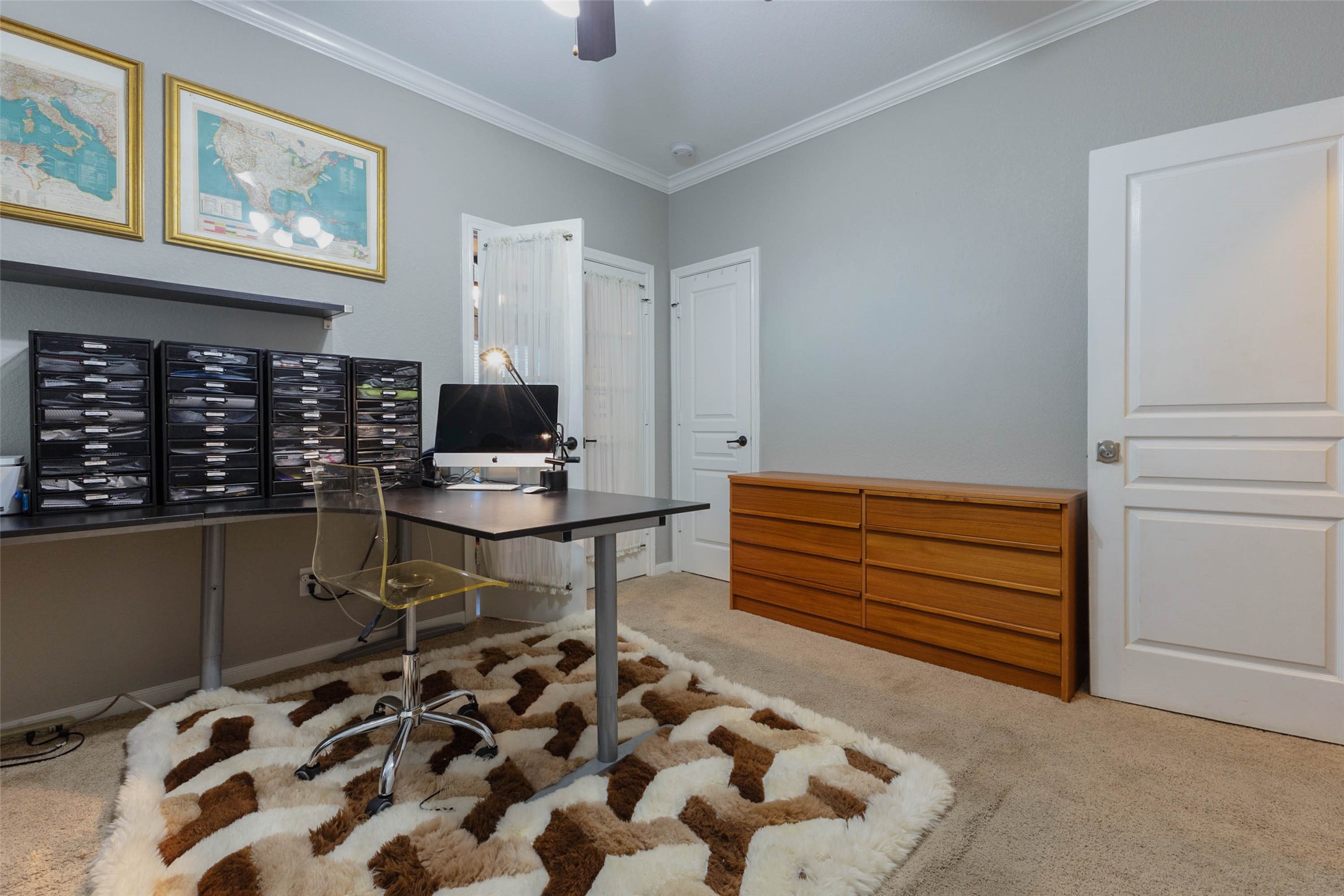 A versatile study with crown molding offers a polished setting for work or additional bedroom accommodations.