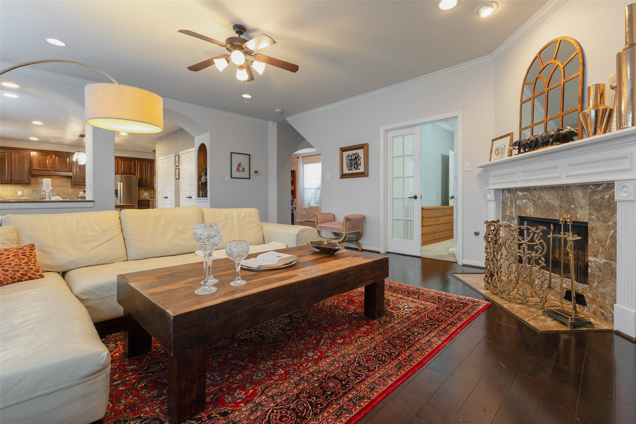 Arched openings provide a seamless transition from the family room to the kitchen with an effortless flow.
