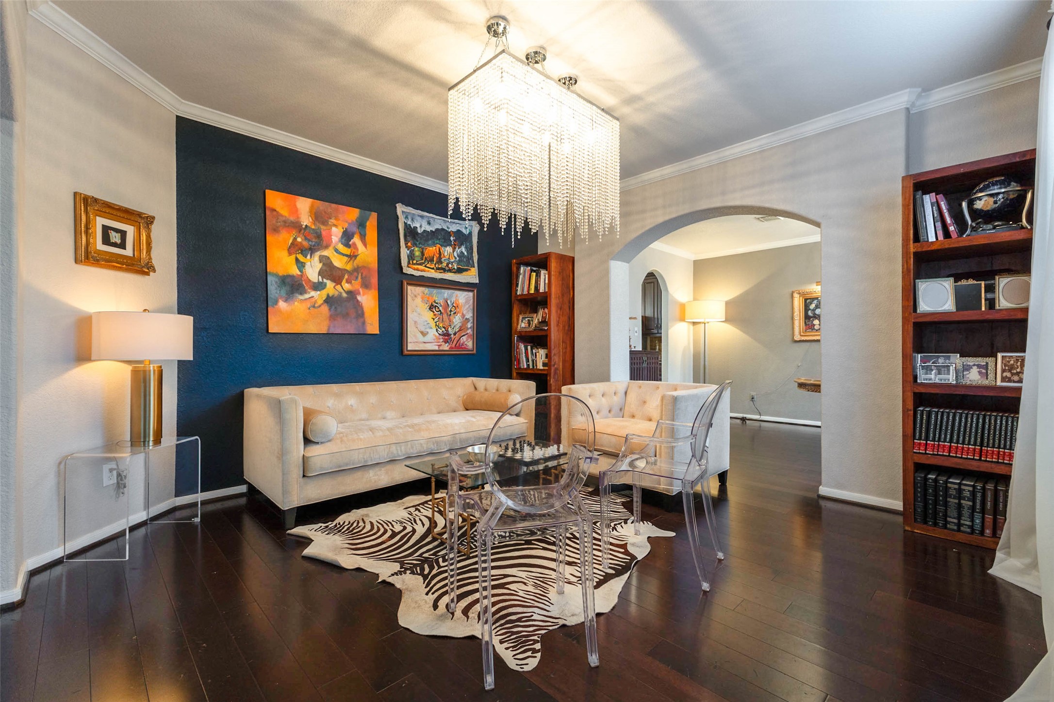 Contemporary lighting, refined archways & contrasting finishes give this formal living area a distinctive, gallery-inspired aesthetic.