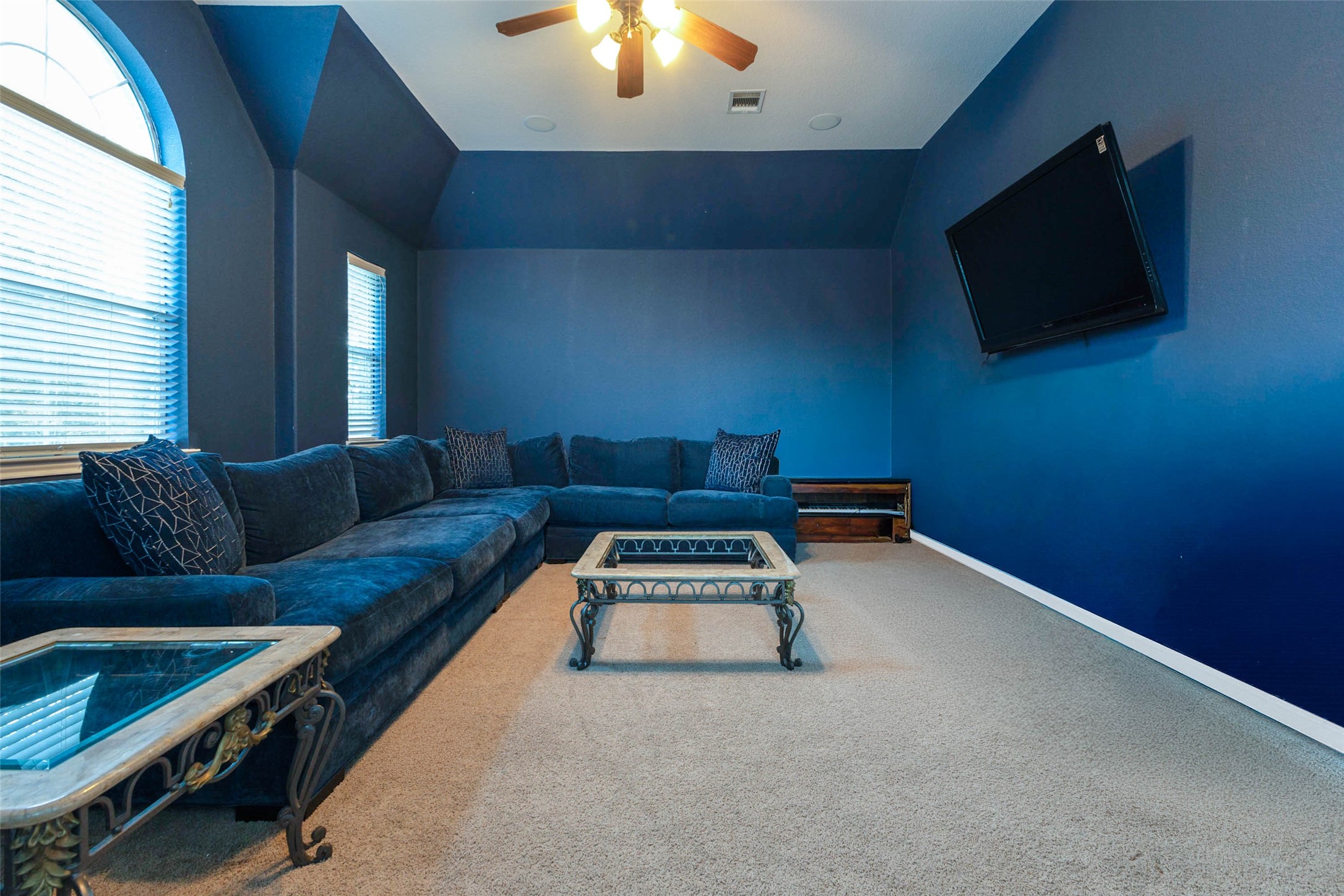 This upstairs entertainment room an ideal destination for movies or hosting game nights.