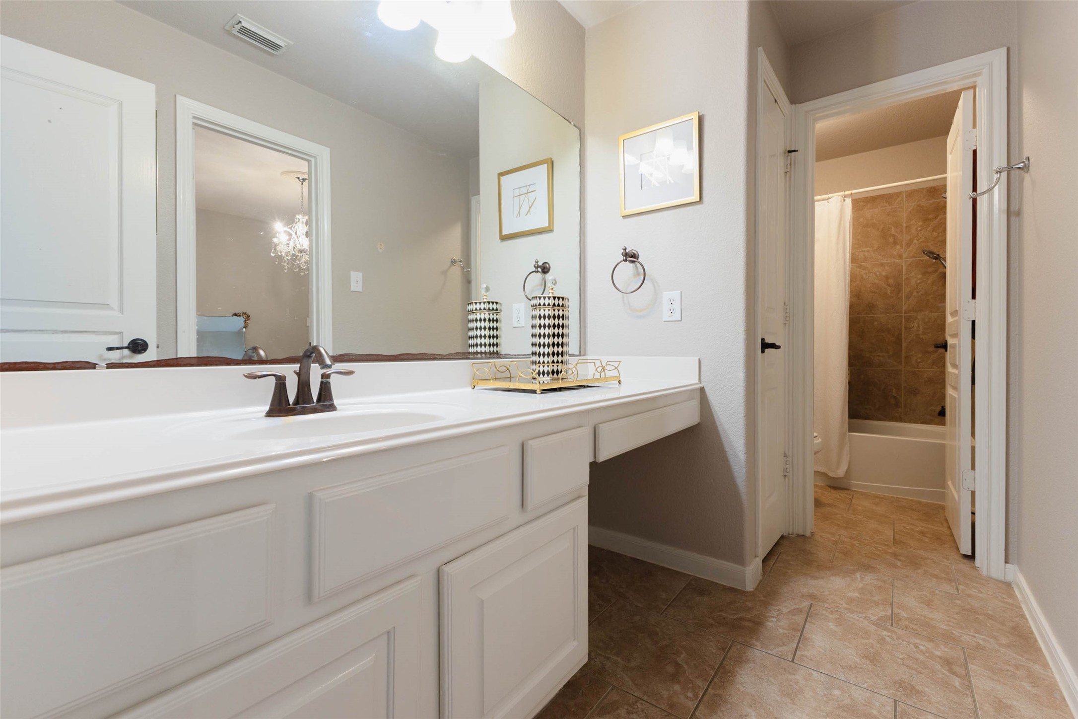 An extended vanity countertop in this secondary bathroom.