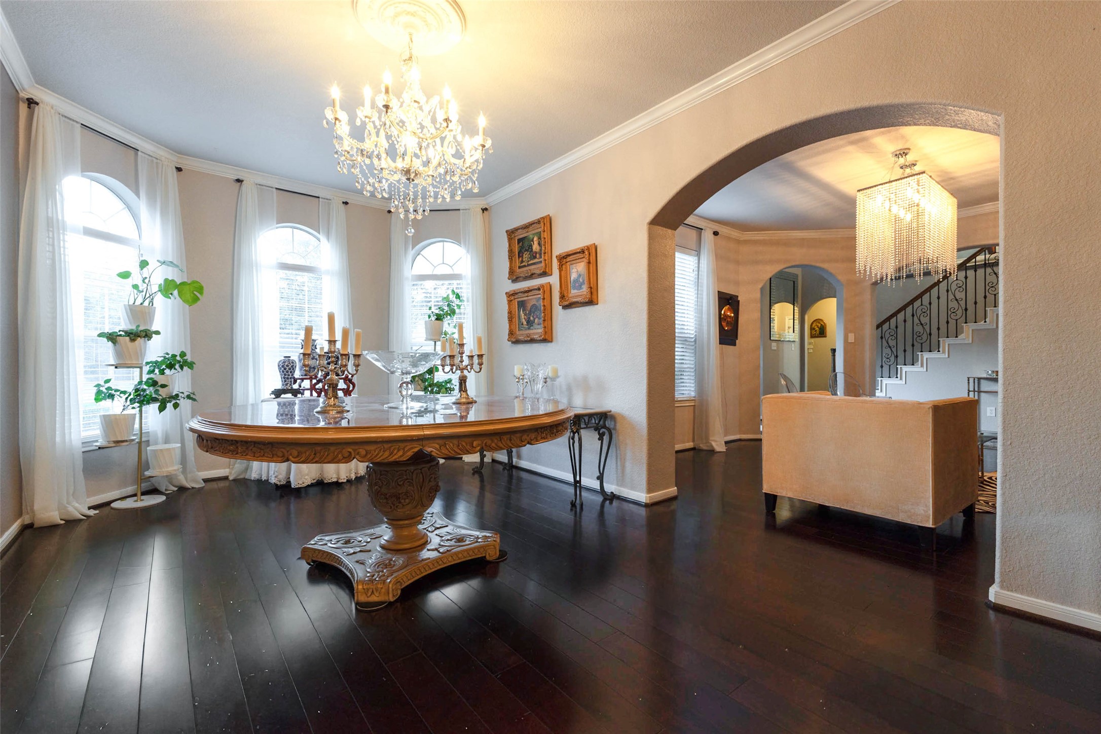 A wall of gracefully arched windows accents an elegant backdrop for entertaining.