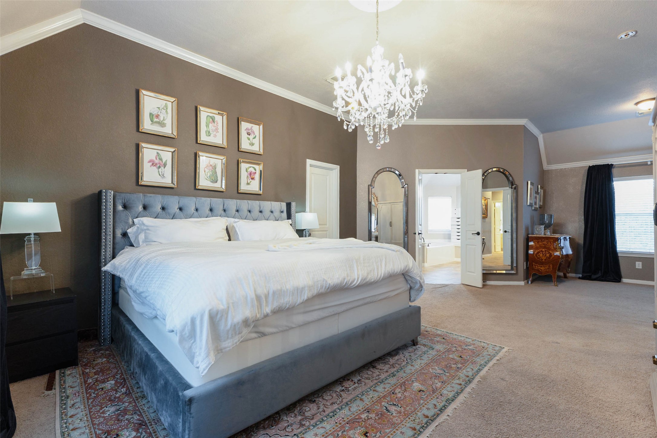 This lux primary bedroom pairs a distinctive paint palette with design driven finishes and pleasant privacy to the en-suite bath.