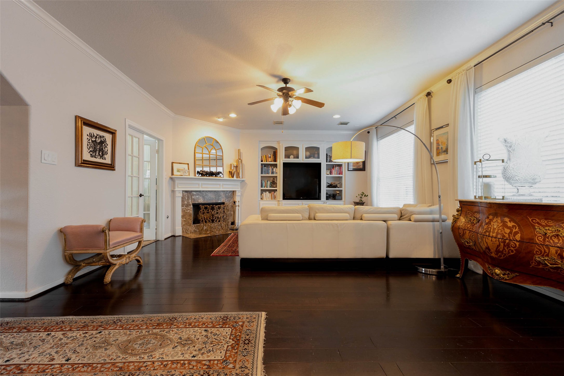 Expansive hardwood flooring connects the main living spaces, while a fireplace & custom entertainment built-ins establish a comfortable gathering place.