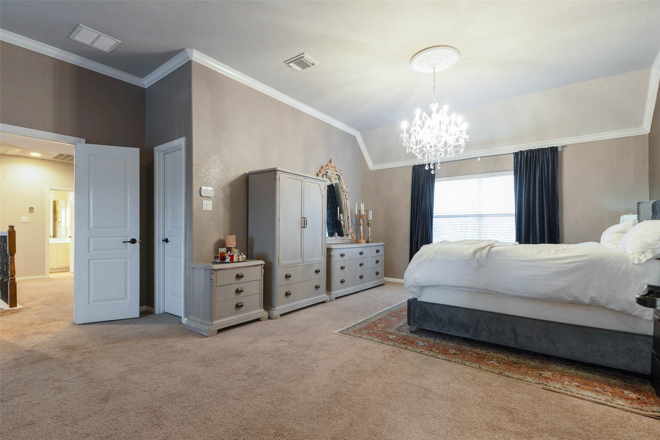 This expansive second-story primary suite exudes timeless elegance.