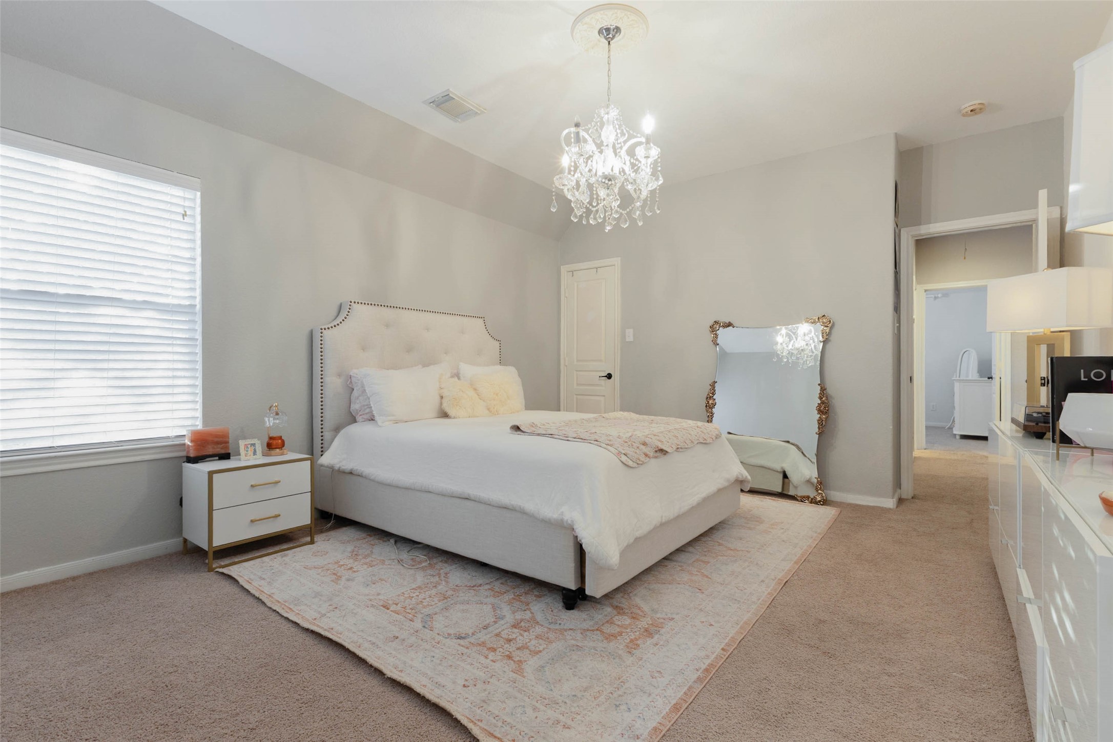 This secondary bedroom boasts a graceful blend of comfort and style.