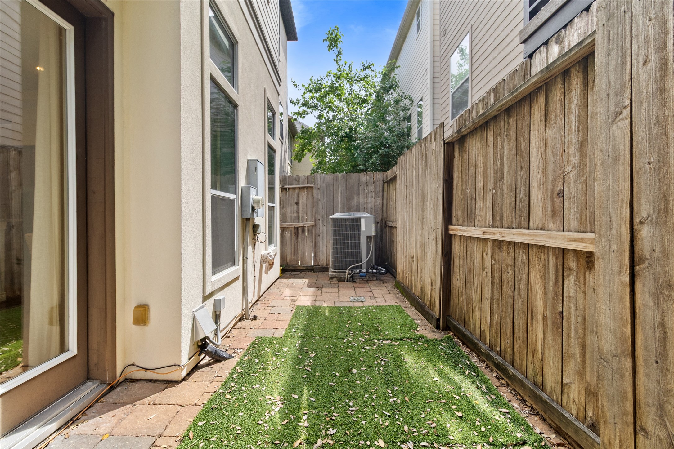 You step outside to a private side yard thats perfect for letting pets out, adding a small garden, or just having a bit of fresh air without the upkeep. Its tucked away and easy to maintain.