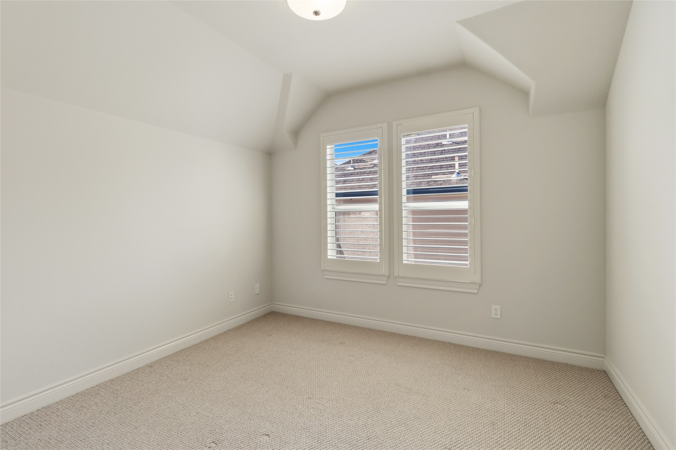You can turn this into whatever you needa quiet guest room, a home office, or your own personal retreat. The angled ceiling adds character while the windows keep the space feeling open and light.
