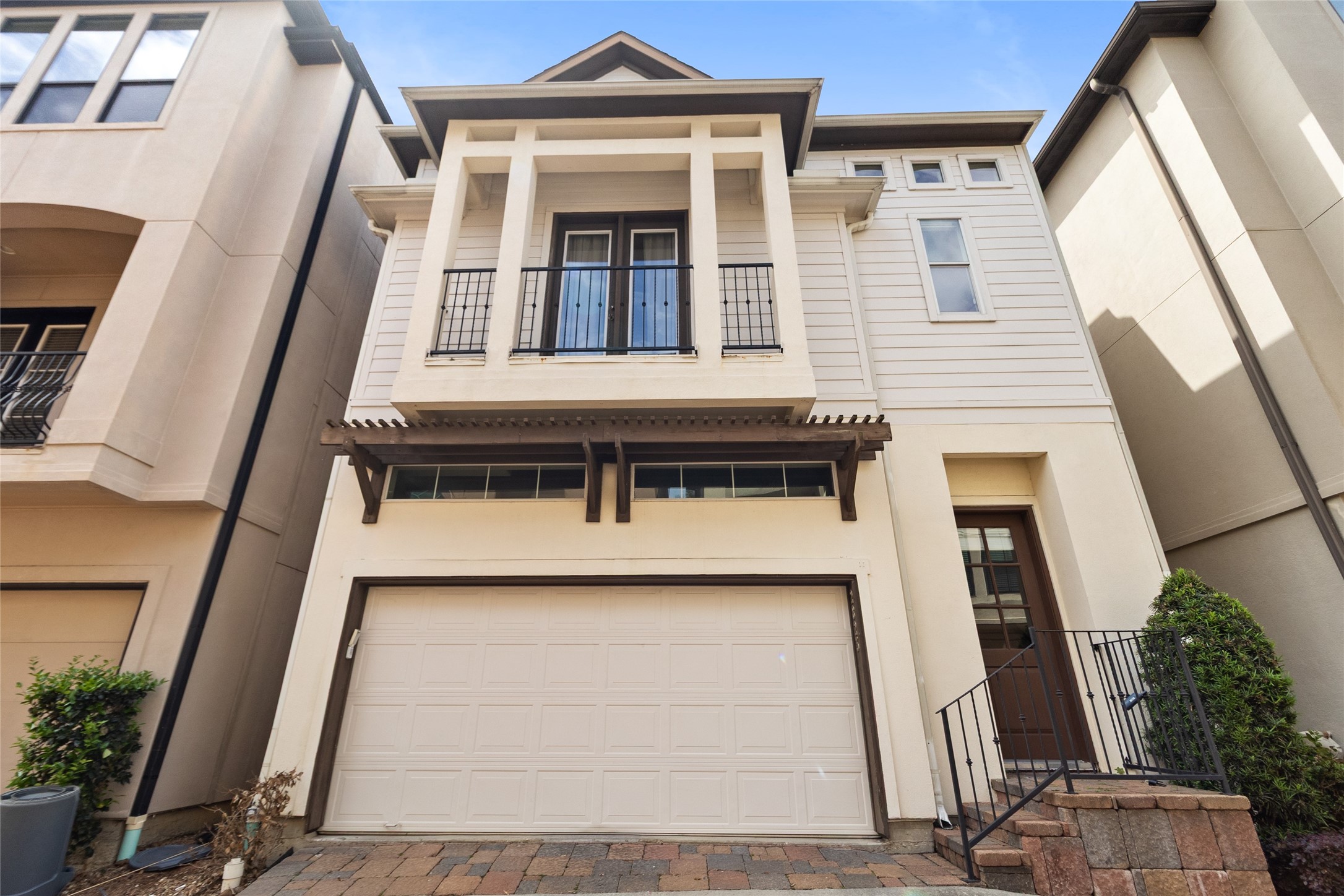 You arrive home to a striking faade that feels both refined and welcoming, with clean architectural lines, warm tones, and your private garage ready for everyday convenience. That upper balcony adds just the right touch of character, giving your home a presence that stands out the moment you pull in.
