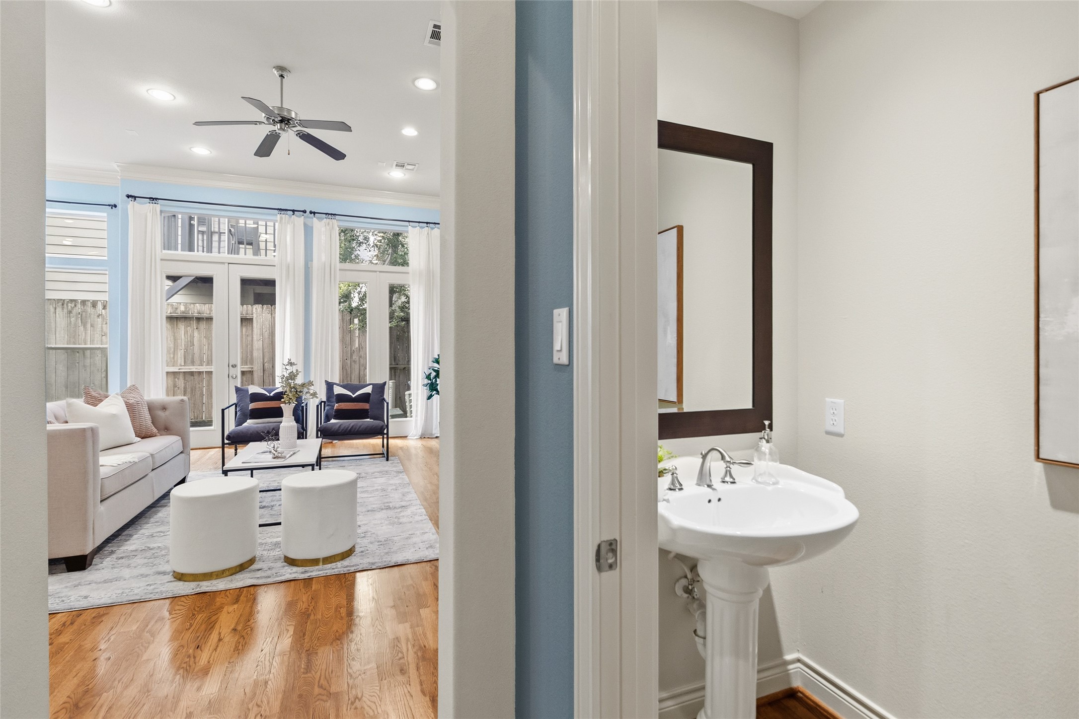 You pass by the powder bathperfectly placed for guestswhile your living room opens up ahead, bright and inviting. Its the kind of layout that keeps everything flowing without ever feeling crowded.