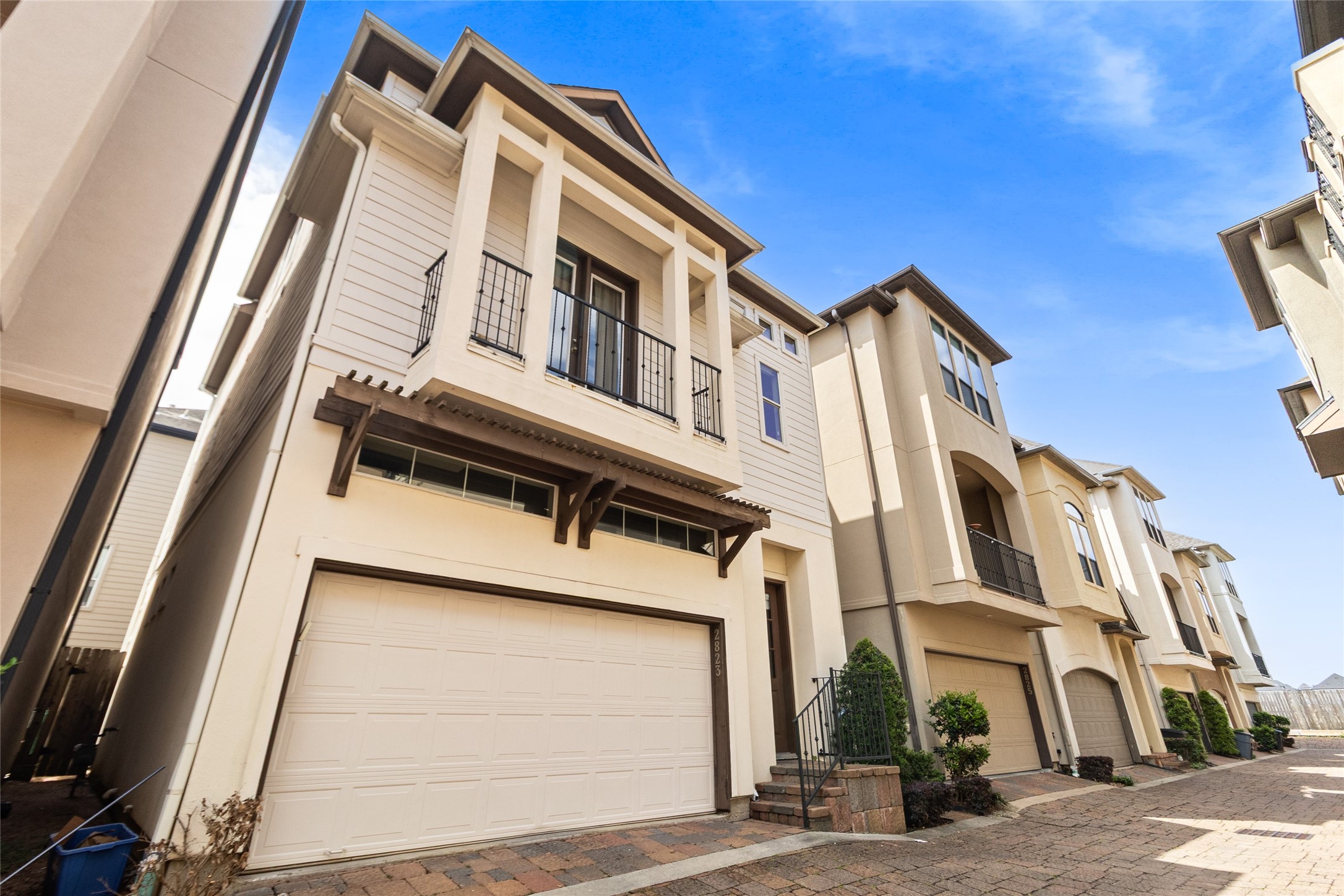 You pull up to a home that stands out with its clean lines, balcony detail, and private garage, all set within a well-kept community. Its the kind of exterior that feels just as polished as everything inside.