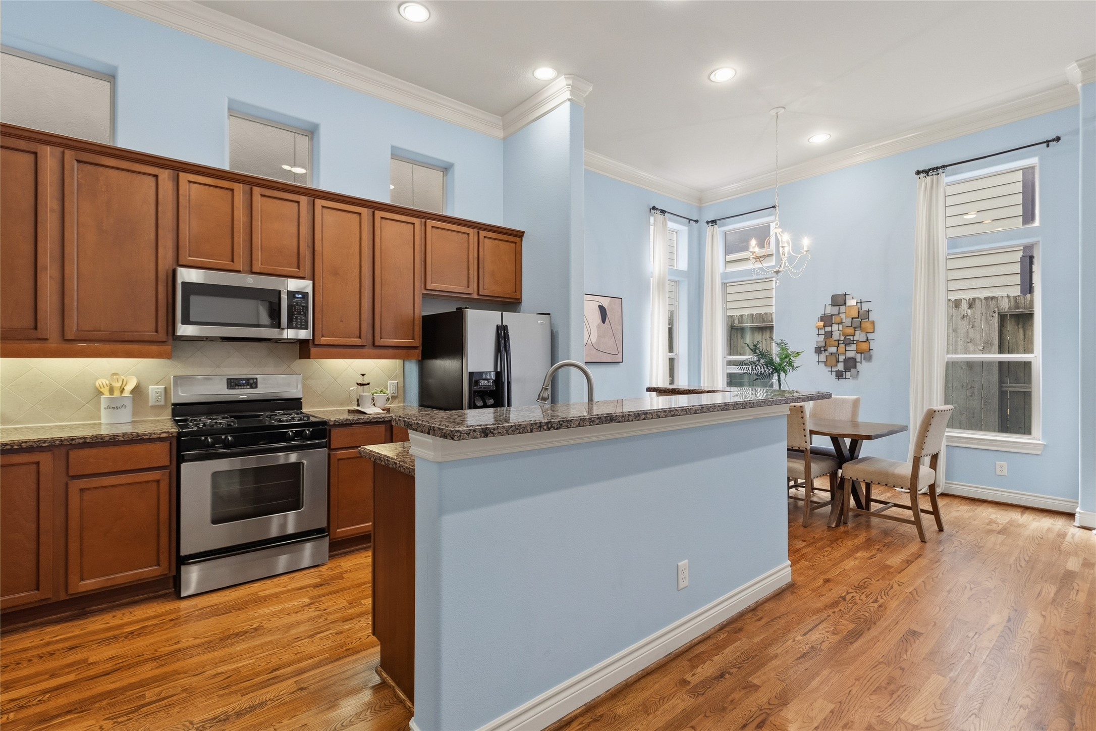 Youre cooking here while still staying connected to everythingthe island becomes your go-to spot for quick meals, conversations, or a glass of wine. Just beyond, your dining space sits wrapped in natural light, making every meal feel easy and relaxed.