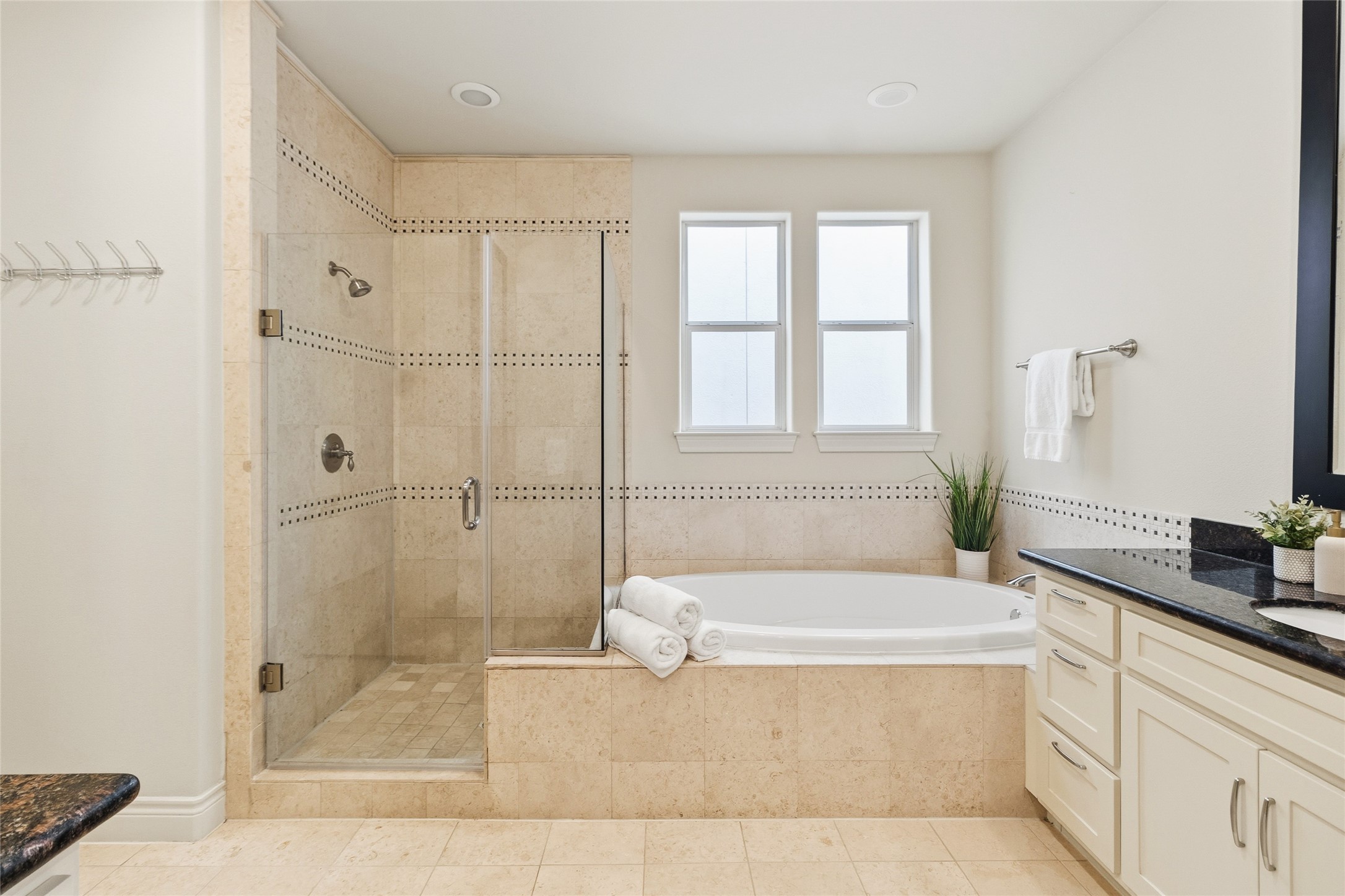 You can unwind in a deep soaking tub or step into the separate glass showerboth finished with clean tile and a spa-like feel. Its your own private space to reset without ever leaving home.