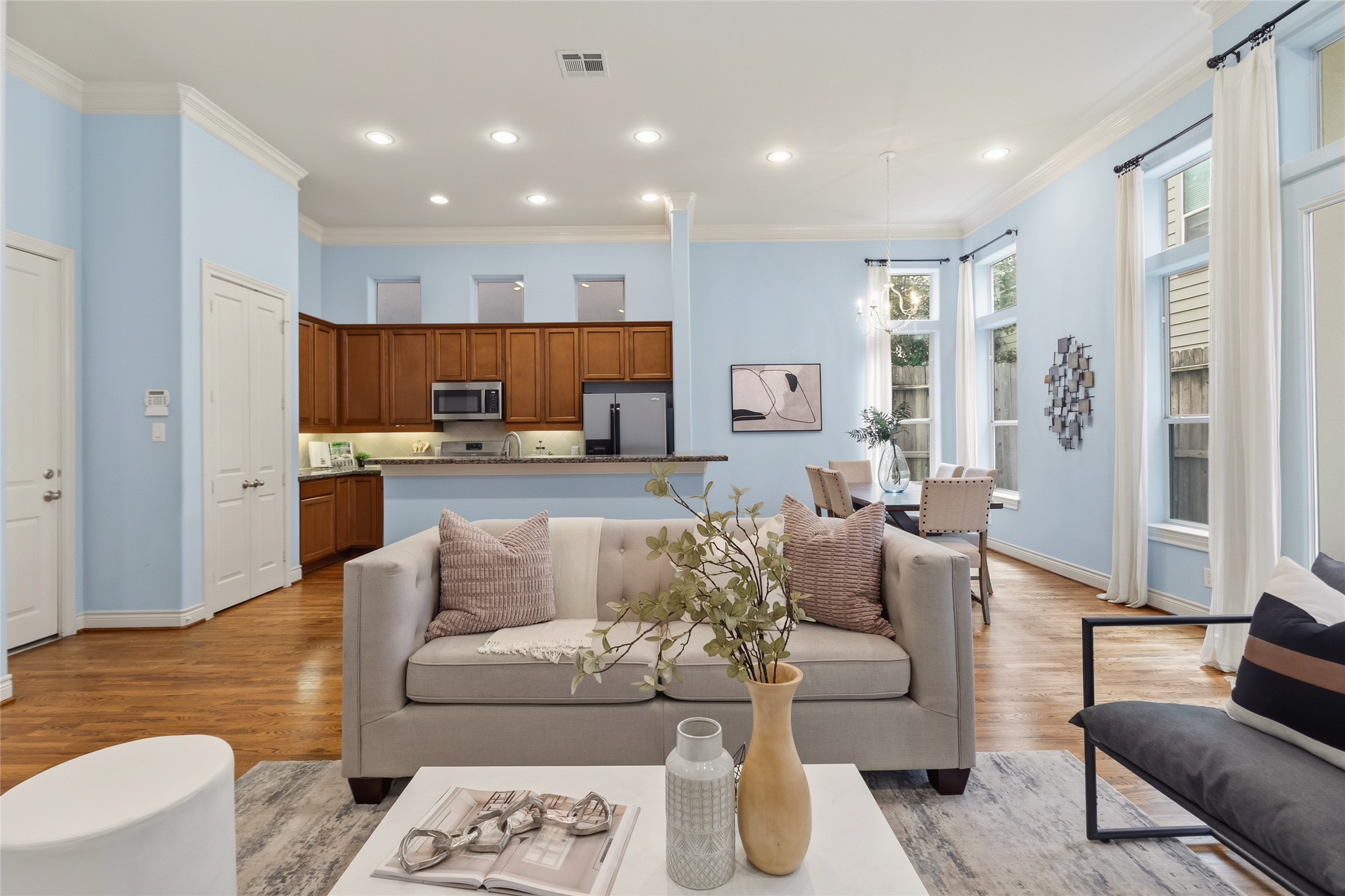From your spot on the couch, youve got a full view of the kitchen and dining area, making it easy to stay connected whether youre hosting or just relaxing. Everything feels open, yet still defined.