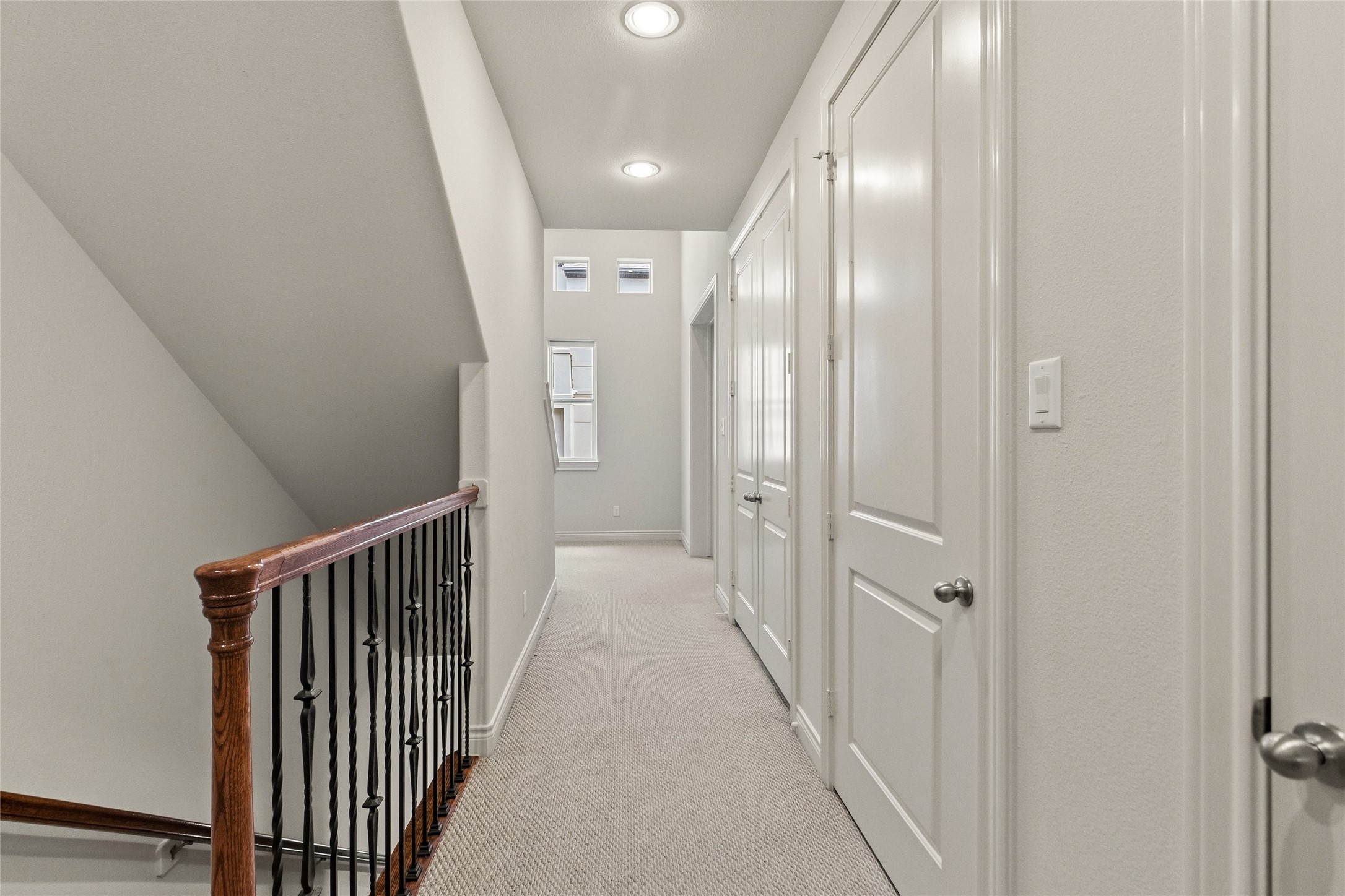 On the second floor, your bright hallway lined with storage, keeping everything tucked away while still within reach. It connects the upper level in a way that feels clean and easy to navigate.