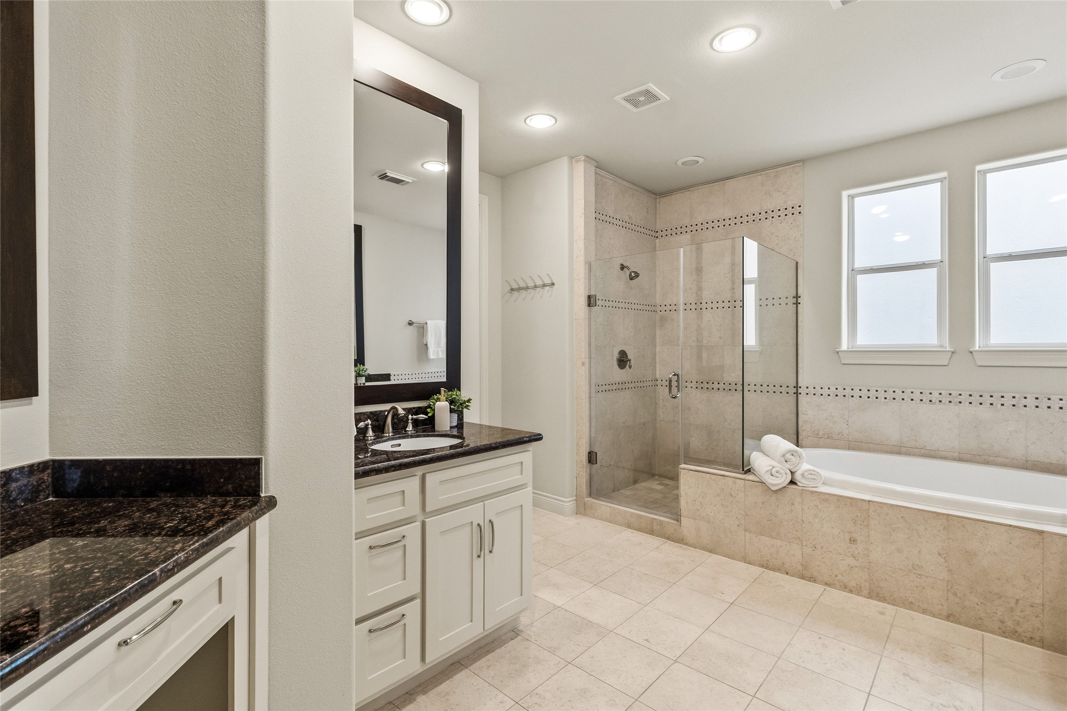You start your mornings here with plenty of counter space and a layout that keeps everything organized and within reach. The walk-in shower and soaking tub give you options depending on how your day starts or ends.