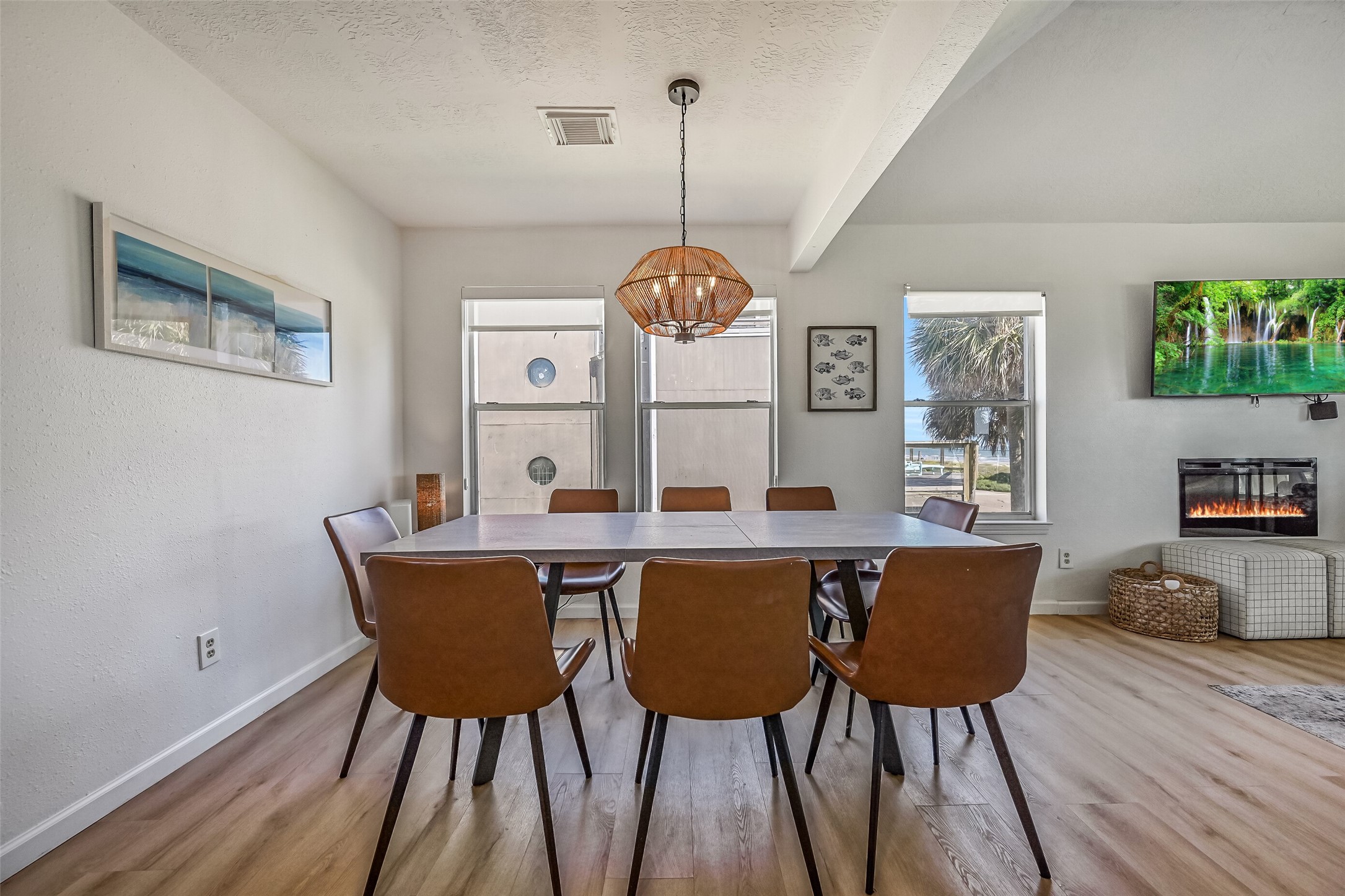 The spacious dining area currently accommodates a table for six, with plenty of room for a larger table, making it ideal for hosting family and friends.