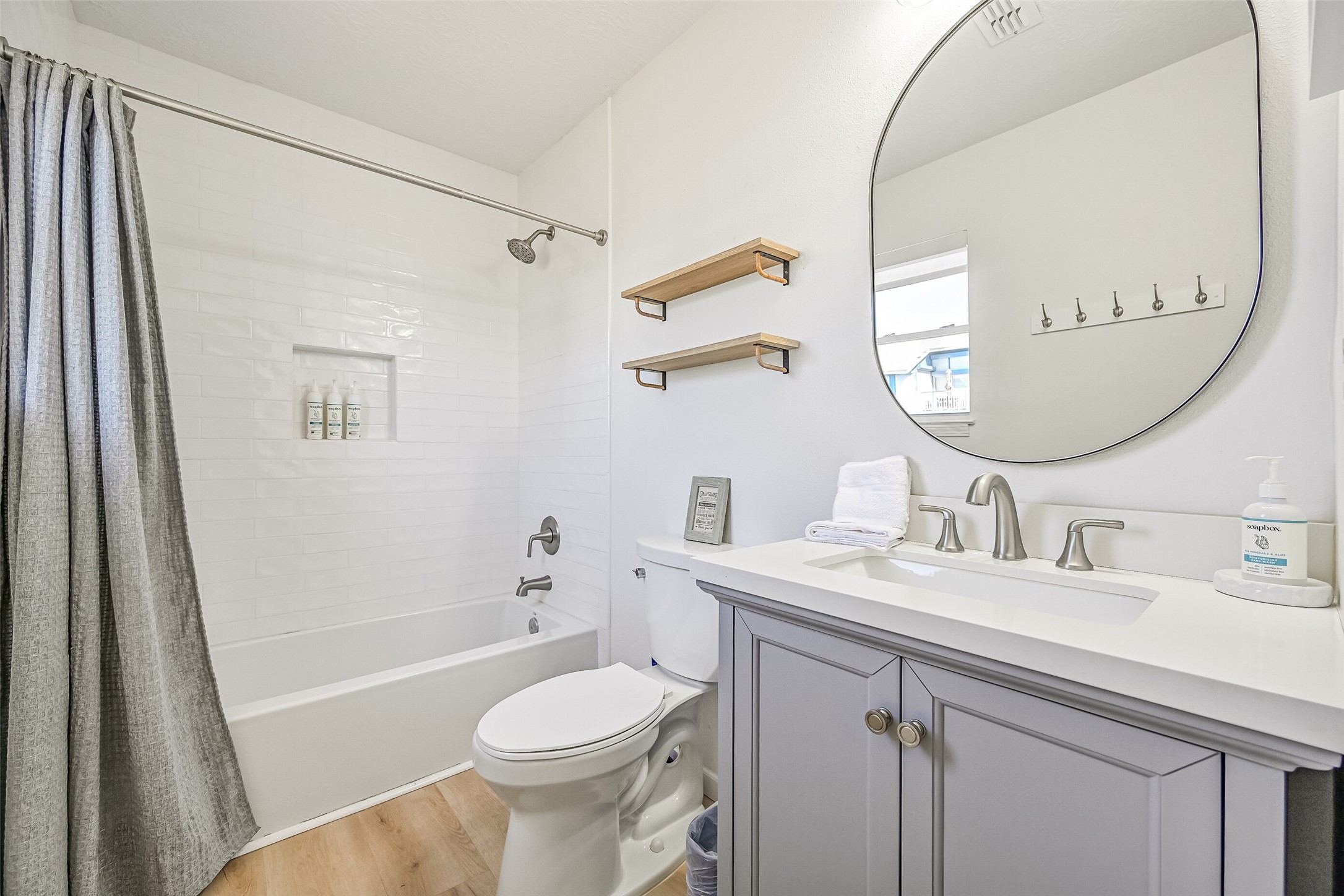 The renovated primary bathroom features a tub and shower combination.