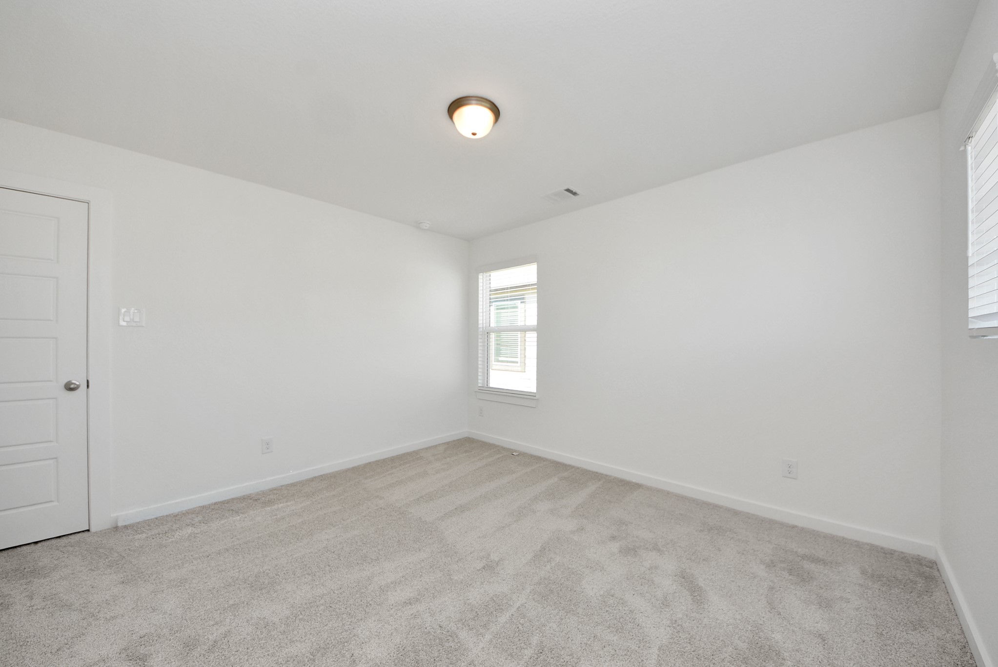 Generously sized secondary bedrooms featuring spacious closets, soft and inviting carpeting underfoot, large windows allowing plenty of natural light, and the added touch of privacy blinds for your personal retreat.