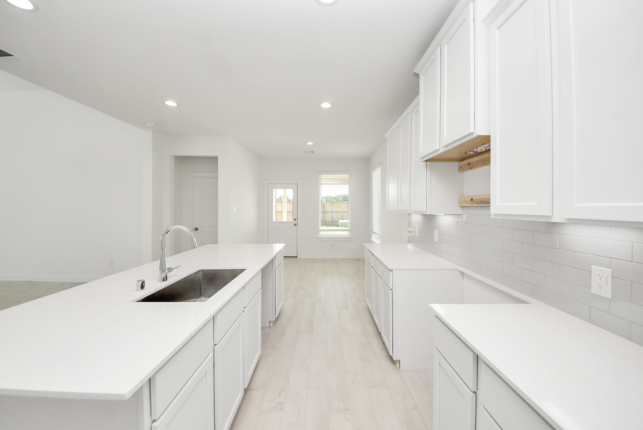 The open concept effortlessly connects the kitchen to the expansive family room, forming a perfect hub for gatherings. This seamless flow creates an inviting space where cooking and socializing come together harmoniously.
