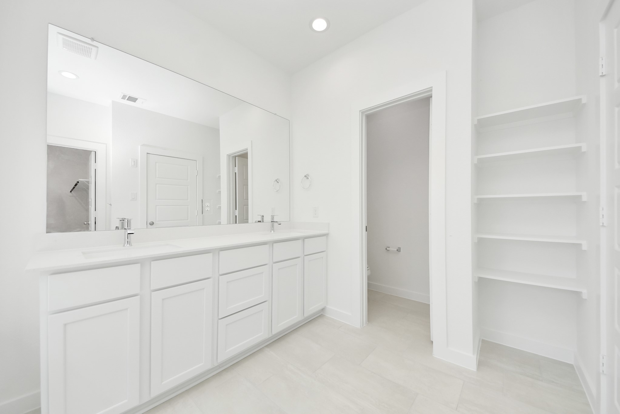 Escape to a spa-like oasis in this primary bathroom. Enjoy a walk-in shower with tile surround, a separate garden tub with custom detailing, and an elegant vanity featuring light countertops, modern hardware, and beautiful vanity lights. Experience luxury and relaxation in every detail.