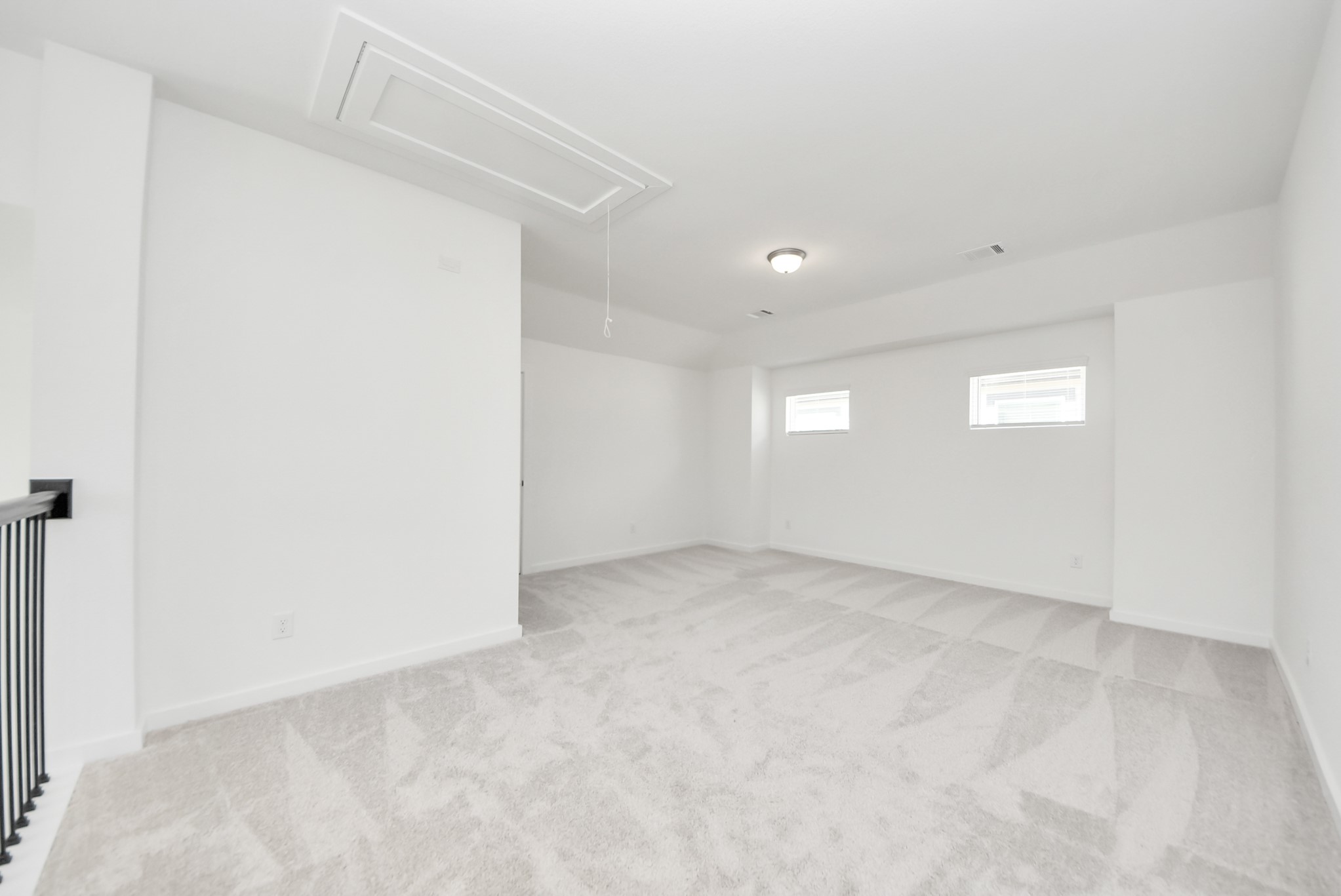Come upstairs and enjoy a day of leisure in this fabulous game room! This is the perfect hangout spot or adult game room! Features plush carpet, high ceilings, custom paint and windows for plenty of natural light.