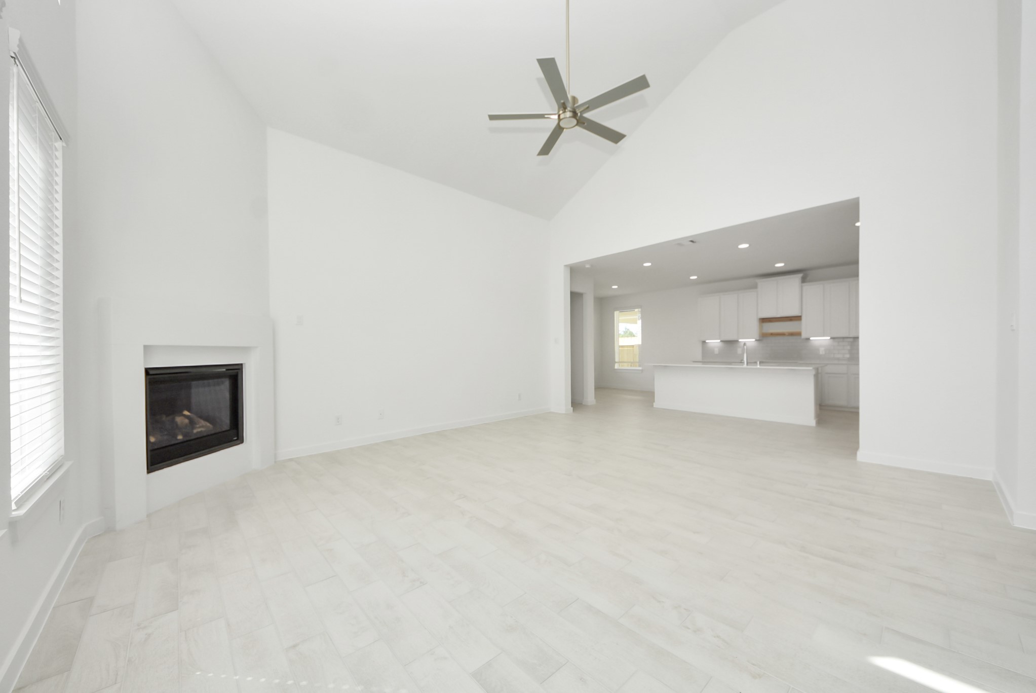 Gather the family and guests together in your lovely living room! Featuring soaring high ceilings, recessed lighting, ceiling fan, custom paint, gorgeous floors, and large windows that provide plenty of natural lighting throughout the day.