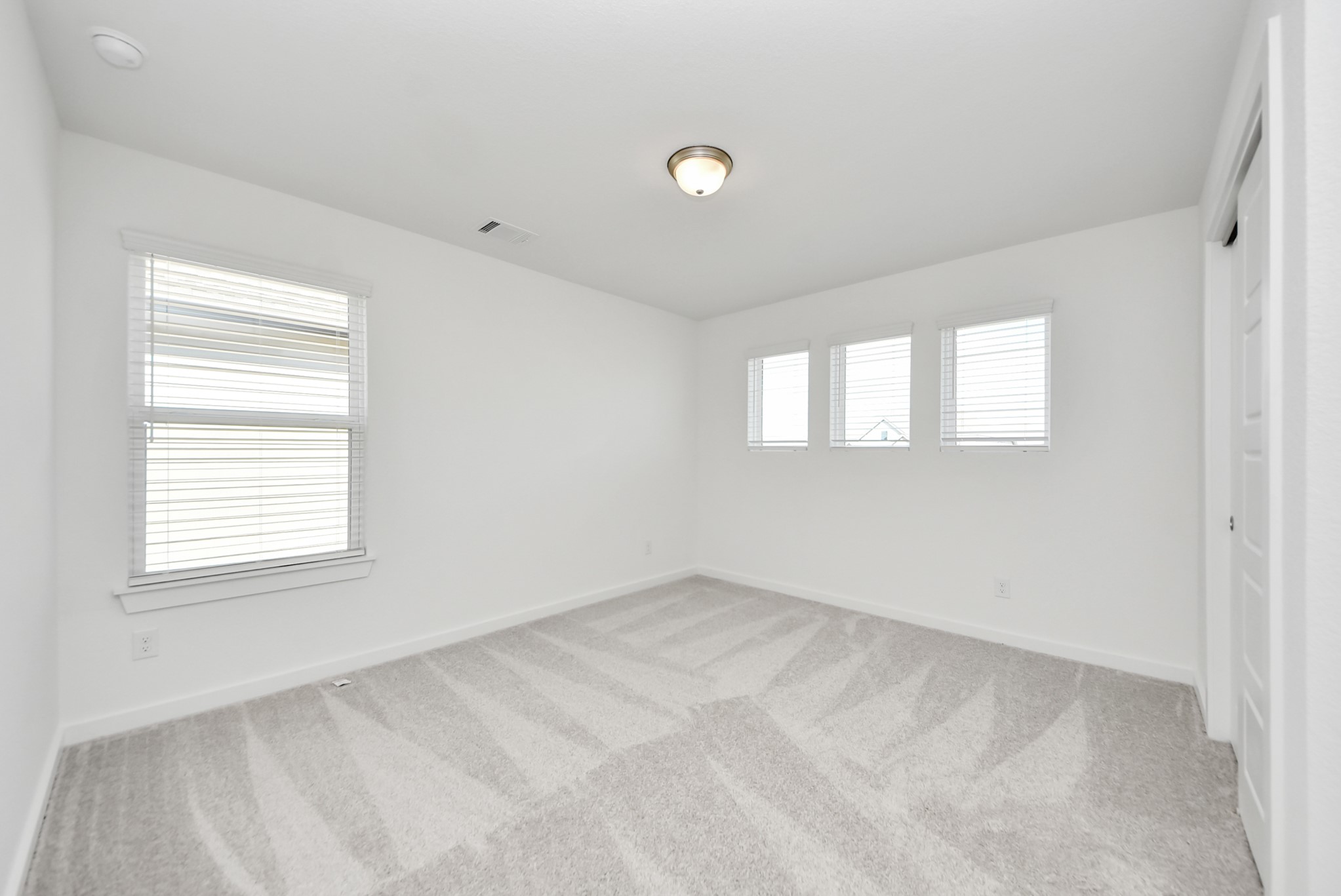 Discover a haven of leisure in this fantastic game room! Whether you're seeking a casual hangout or an adult gaming retreat, this space has it all. Enjoy the luxurious feel of plush carpet underfoot, the expansive ambiance of high ceilings, custom paint that adds a touch of personality, and windows that flood the room with refreshing natural light.
