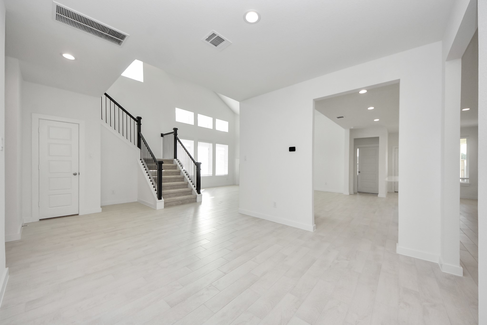 Create lasting memories with your family and friends at the dining table! This expansive dining room showcases sophisticated flooring, custom paint, and seamlessly connects to the family room and kitchen, providing an open and inviting atmosphere
