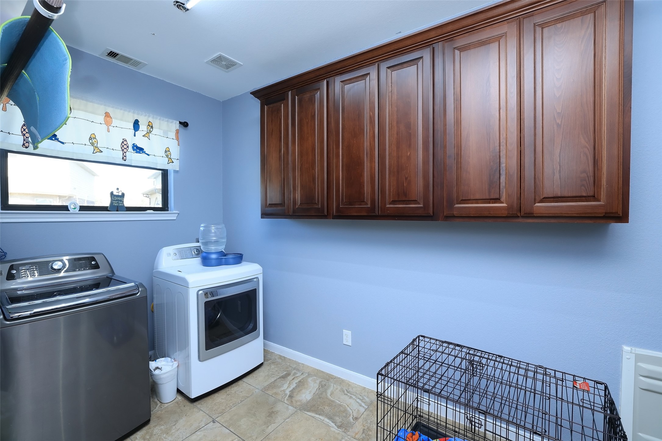 Oversized laundry room with doggy door to fenced side yard