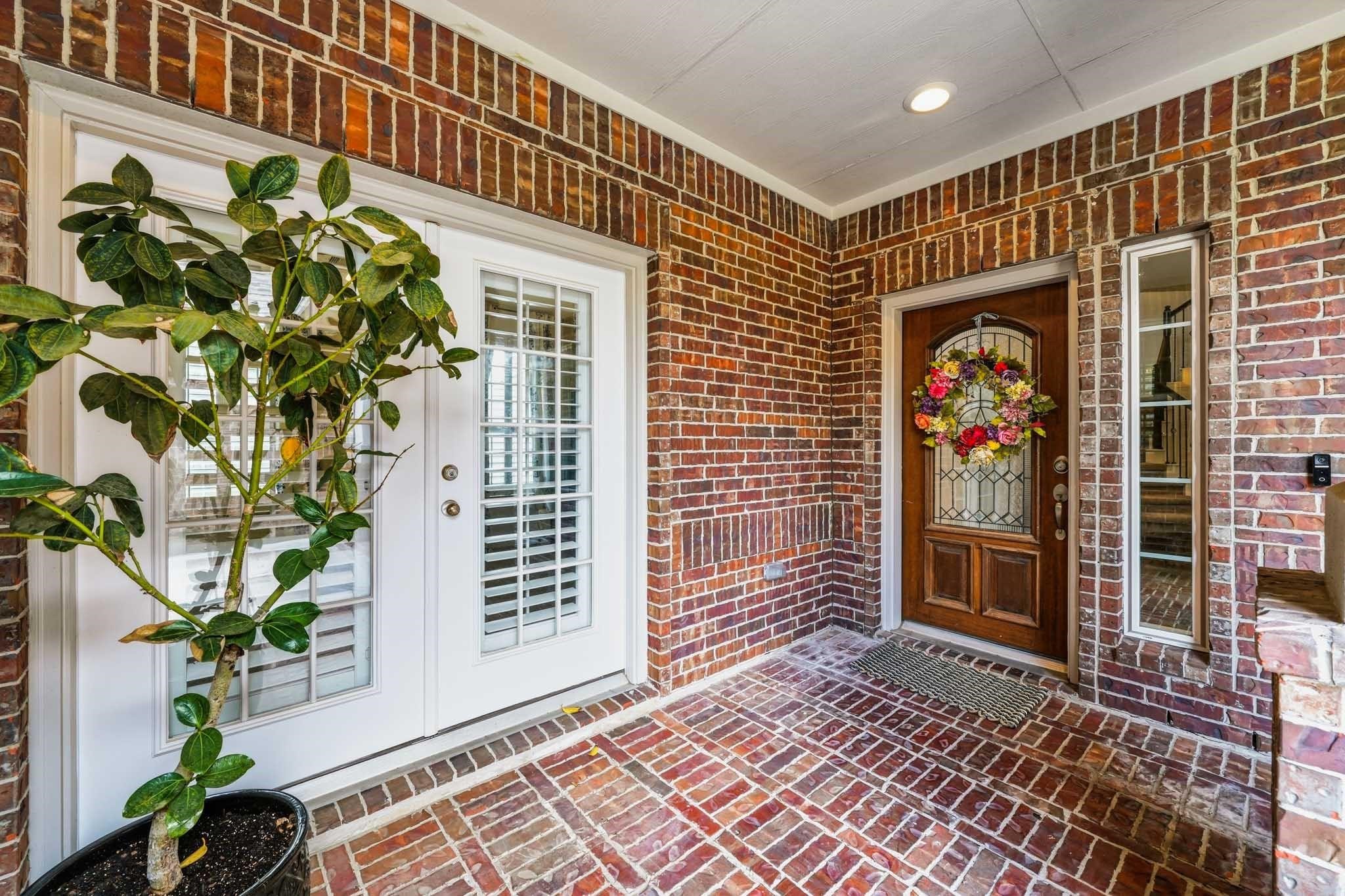 A welcoming covered front porch creates an inviting first impression, with two entrances to the home. One is for the "Next Gen" suite for multigenerational living while the wood and glass entry door leads you to the main home. A welcoming covered front porch creates an inviting first impression, with two entrances to the home. One is for the "Next Gen" suite for multigenerational living while the wood and glass entry door leads you to the main home.