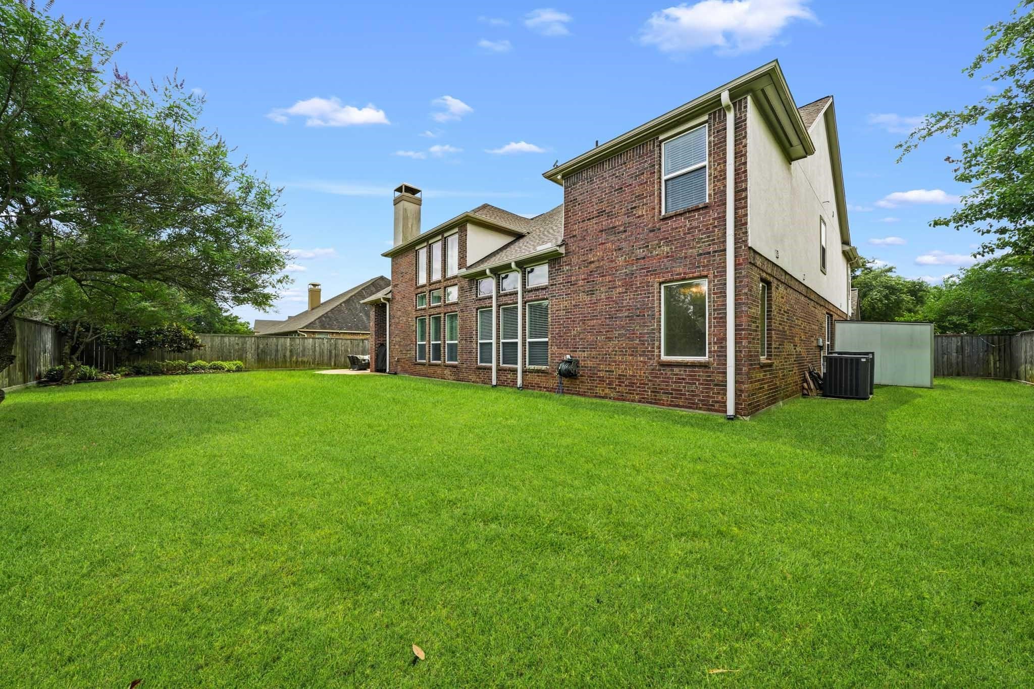 With an abundance of open green space, this remarkable backyard is perfectly suited for play, gardening, outdoor entertaining, or creating the backyard oasis of your dreams.