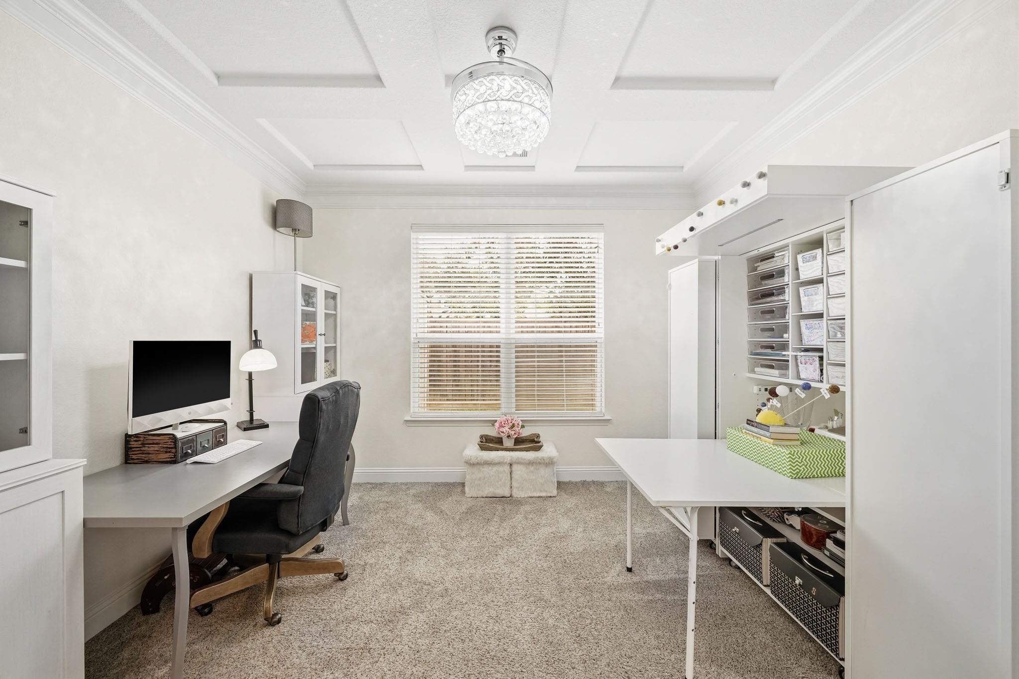A richly detailed coffered ceiling and double crown molding elevate this executive study, offering a refined setting for productivity and inspiration.