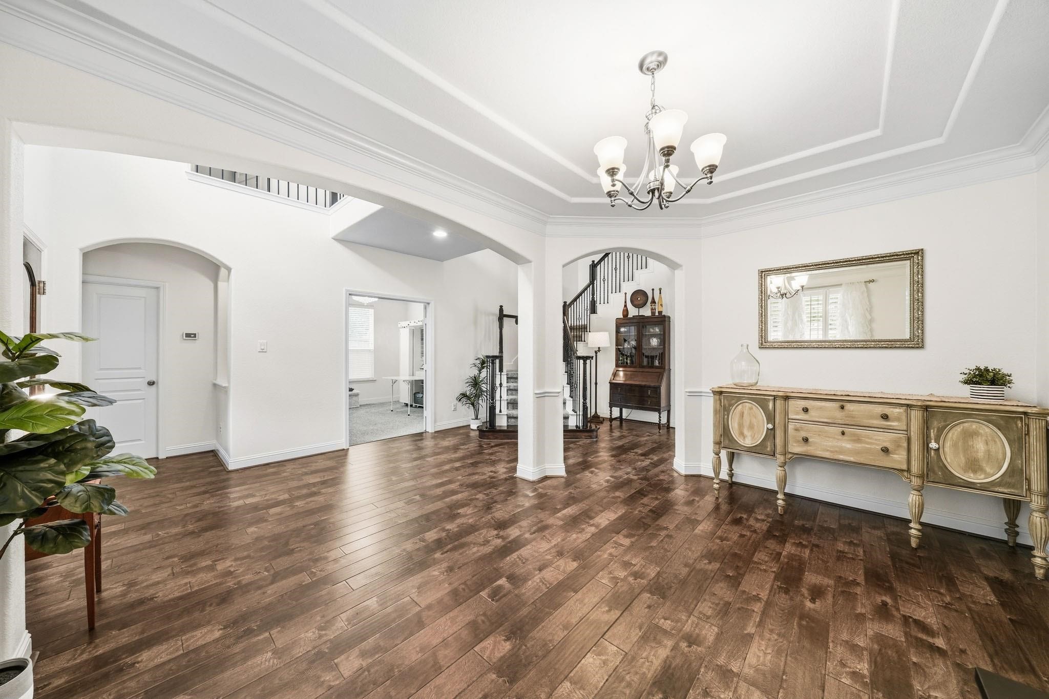 Just to the left is a wall of windows dressed in plantation shutters which brighten the room and offers a welcoming connection to the front porch. Just to the left is a wall of windows dressed in plantation shutters which brighten the room and offers a welcoming connection to the front porch.