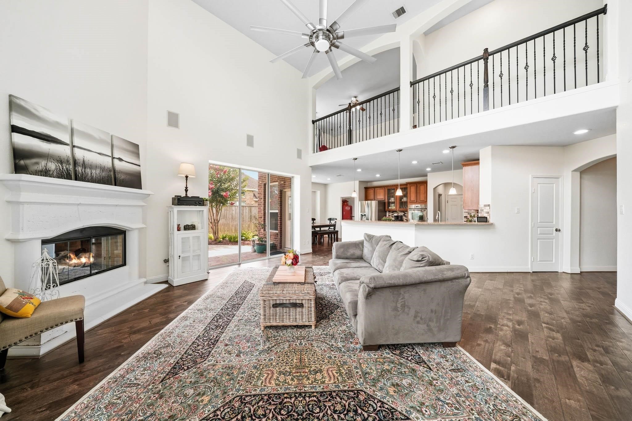 Sophisticated yet inviting, this living space pairs a stunning cast stone fireplace with a nine-foot wide sliding patio door for seamless indoor-outdoor enjoyment. Built-in speakers provide 5.1 surround sound and the family room opens to the kitchen and breakfast room. Sophisticated yet inviting, this living space pairs a stunning cast stone fireplace with a nine-foot wide sliding patio door for seamless indoor-outdoor enjoyment. Built-in speakers provide 5.1 surround sound and the family room opens to the kitchen and breakfast room.
