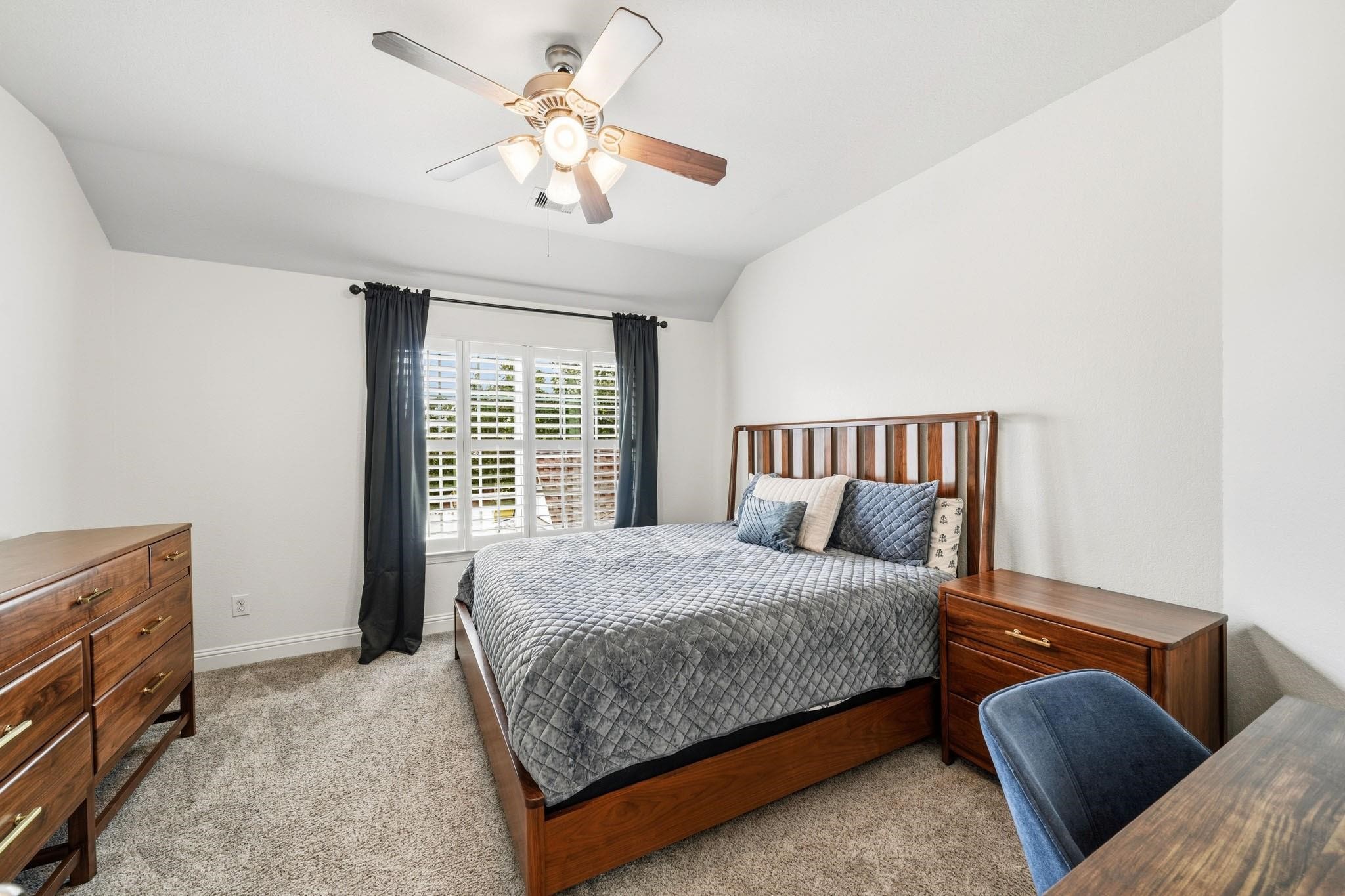 Located just off the landing, the third bedroom feels both private and welcoming, with a tray ceiling adding architectural charm and soft carpet enhancing everyday comfort.