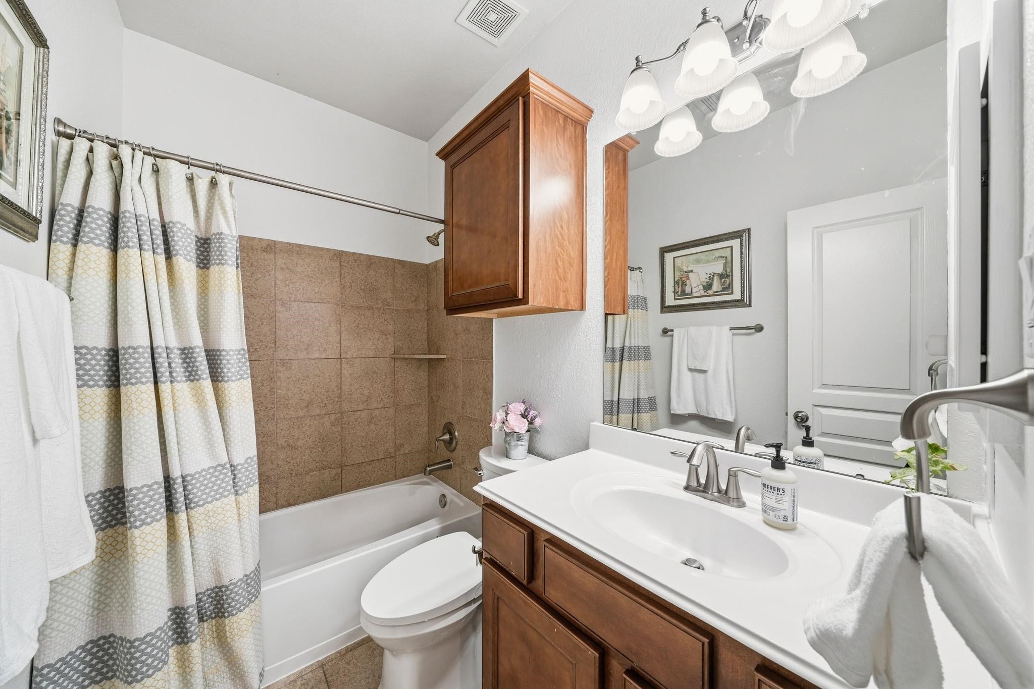 A serene and self-contained retreat, the ensuite bath enhances everyday convenience, while tile floors, a cultured marble sink and a tiled tub-shower surround create a timeless, low-maintenance space.
