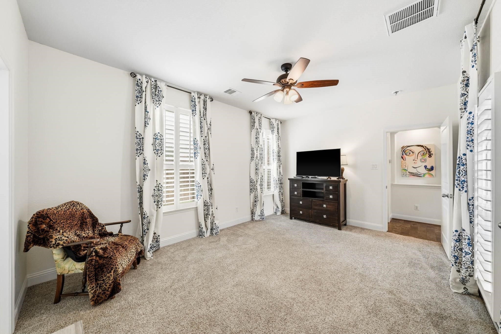 Positioned privately at the front of the home, this secondary bedroom creates a suite-like experience where guests can relax and unwind in complete comfort.