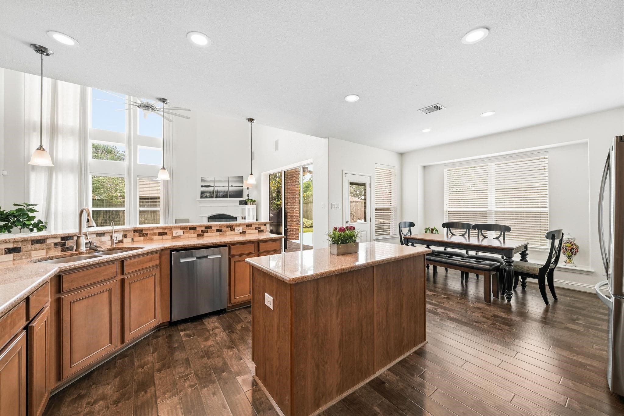 The expansive center island with granite countertop serves as the heart of the kitchen, blending style, function and connection.