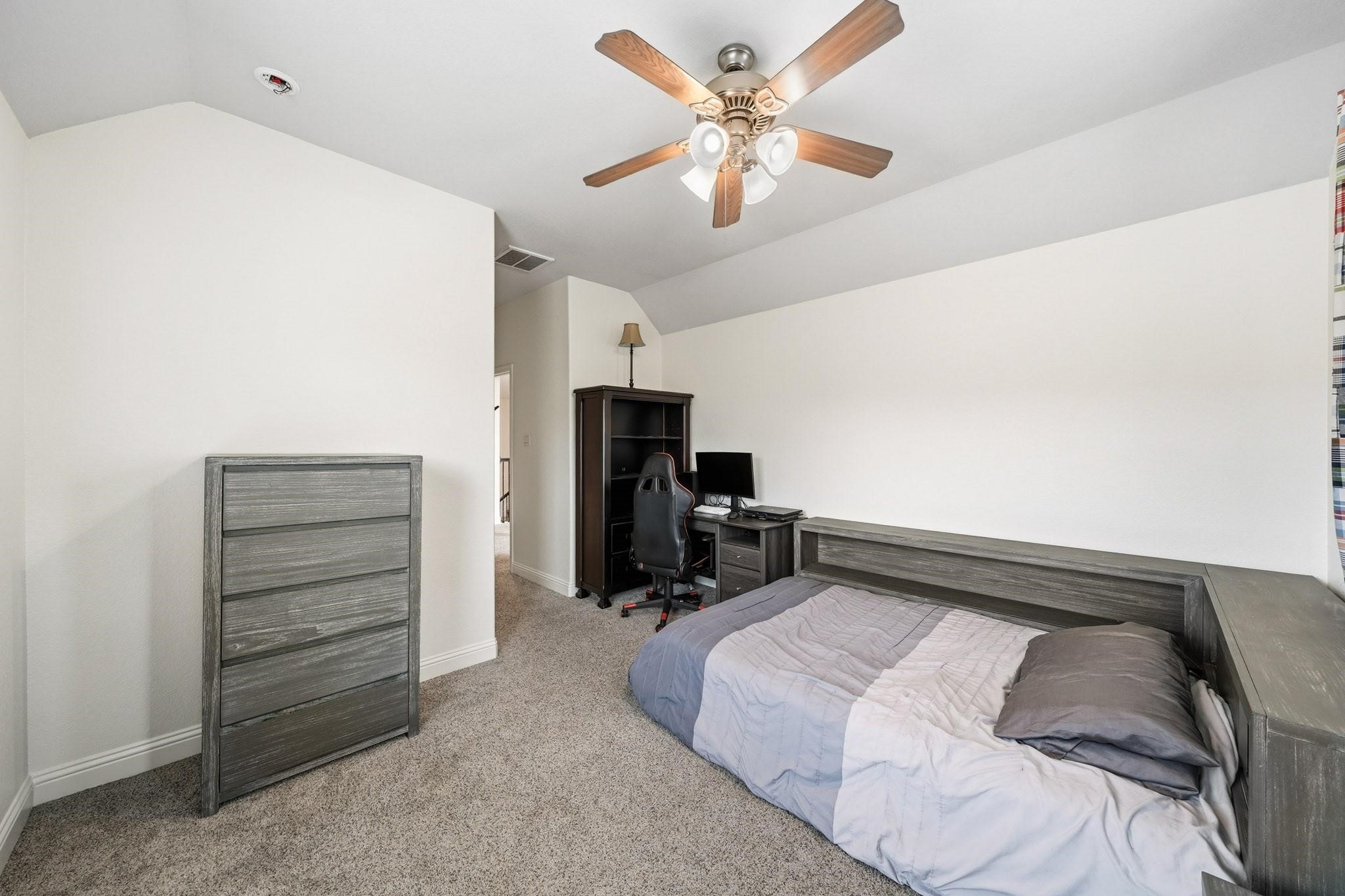 Designed for both comfort and function, this space features natural light and a generous walk-in closet that easily accommodates an extensive wardrobe.