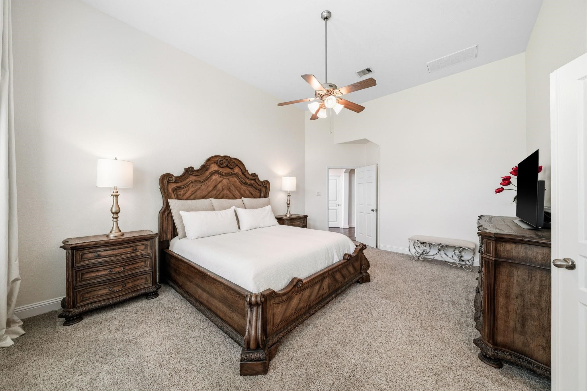 Designed as a private sanctuary, the primary suite showcases tall ceilings and an airy ambiance, creating the perfect place to unwind at the end of the day.