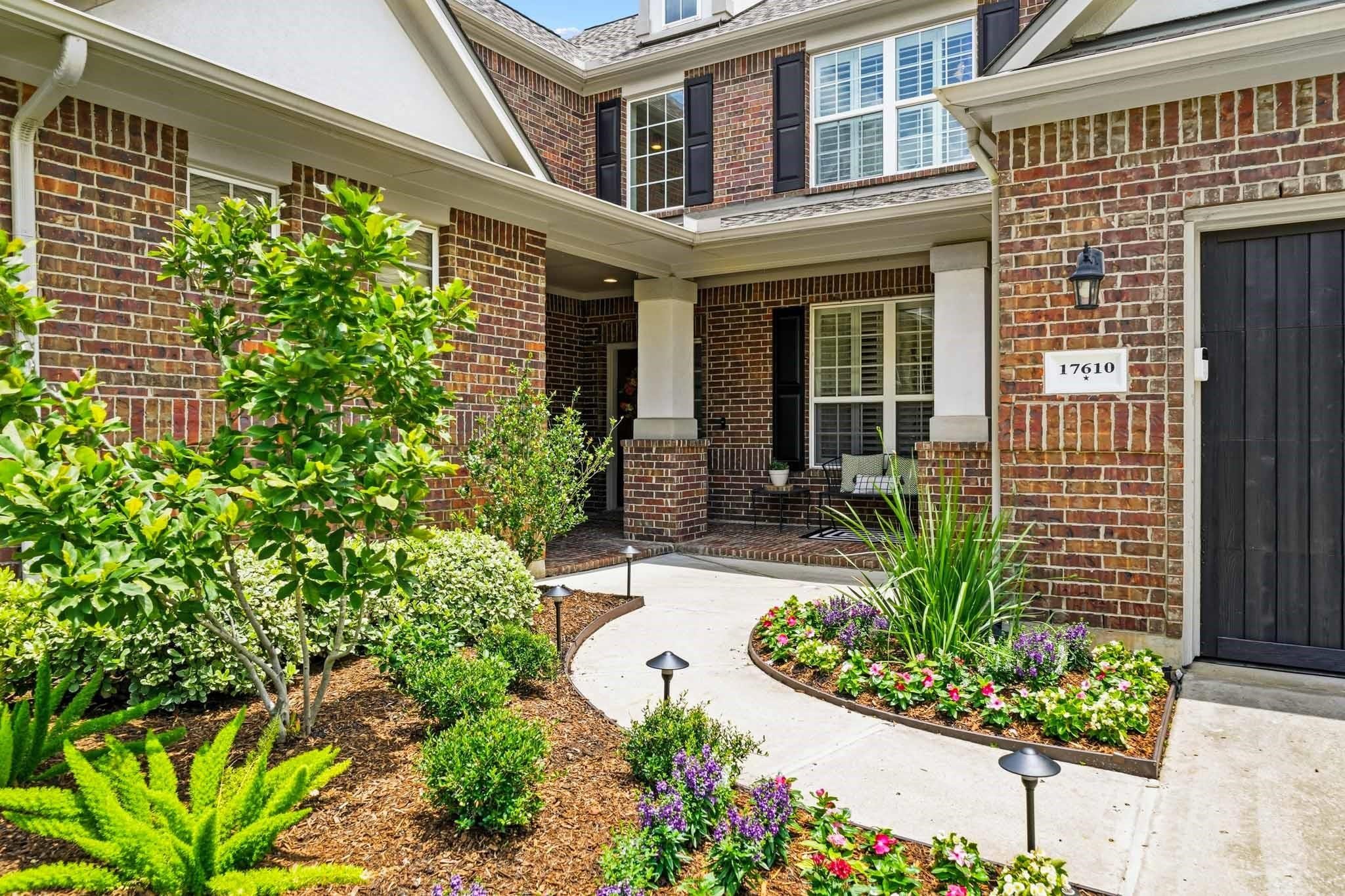 Beautifully positioned on a tree-lined corner lot, the home's timeless brick and stucco exterior is complemented by manicured grounds and professionally installed landscape lighting. Beautifully positioned on a tree-lined corner lot, the home's timeless brick and stucco exterior is complemented by manicured grounds and professionally installed landscape lighting.
