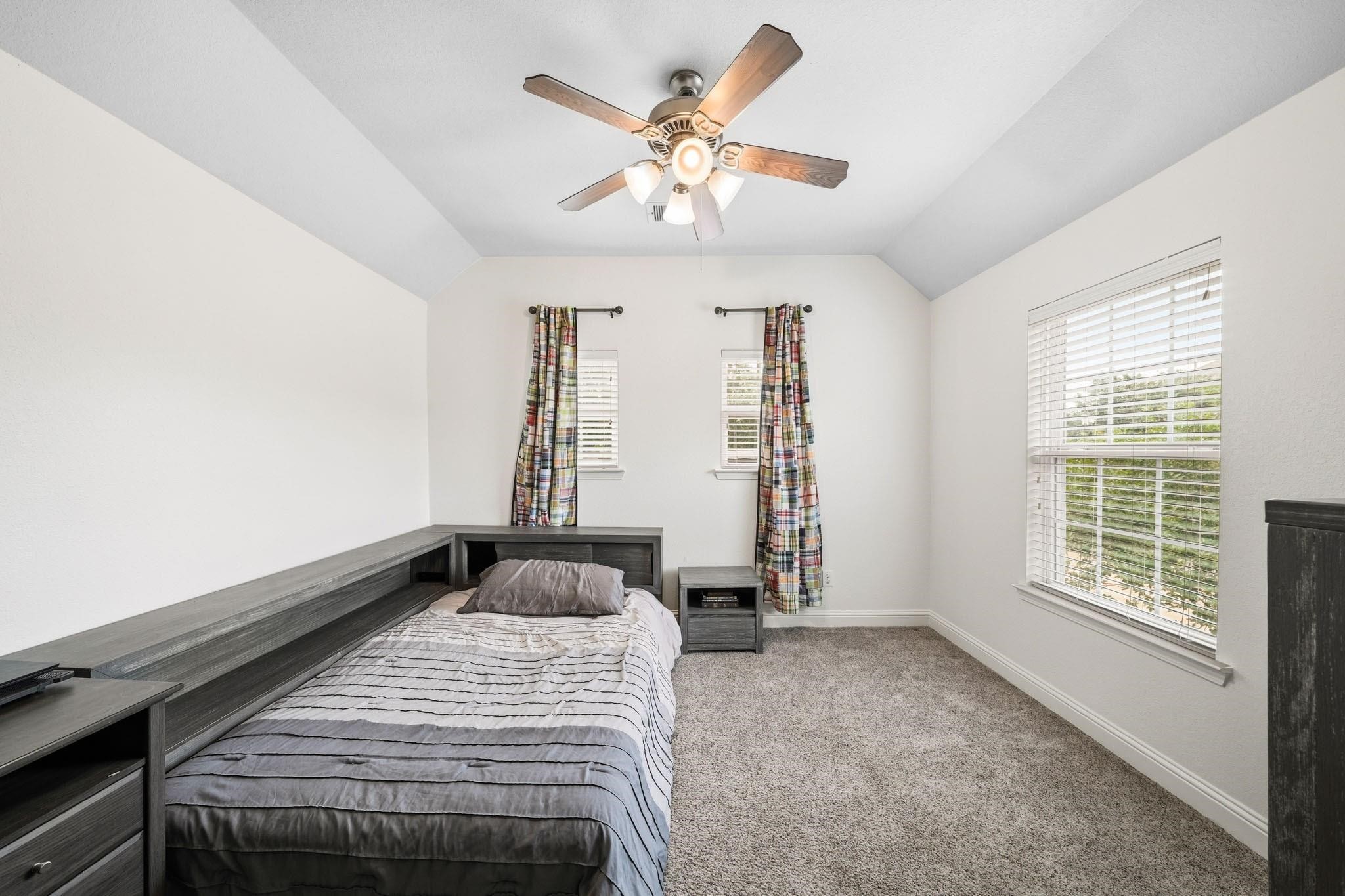 Warm, comfortable, and beautifully appointed, the fifth bedroom features plush carpet and an elegant tray ceiling, making it ideal for family or guests.