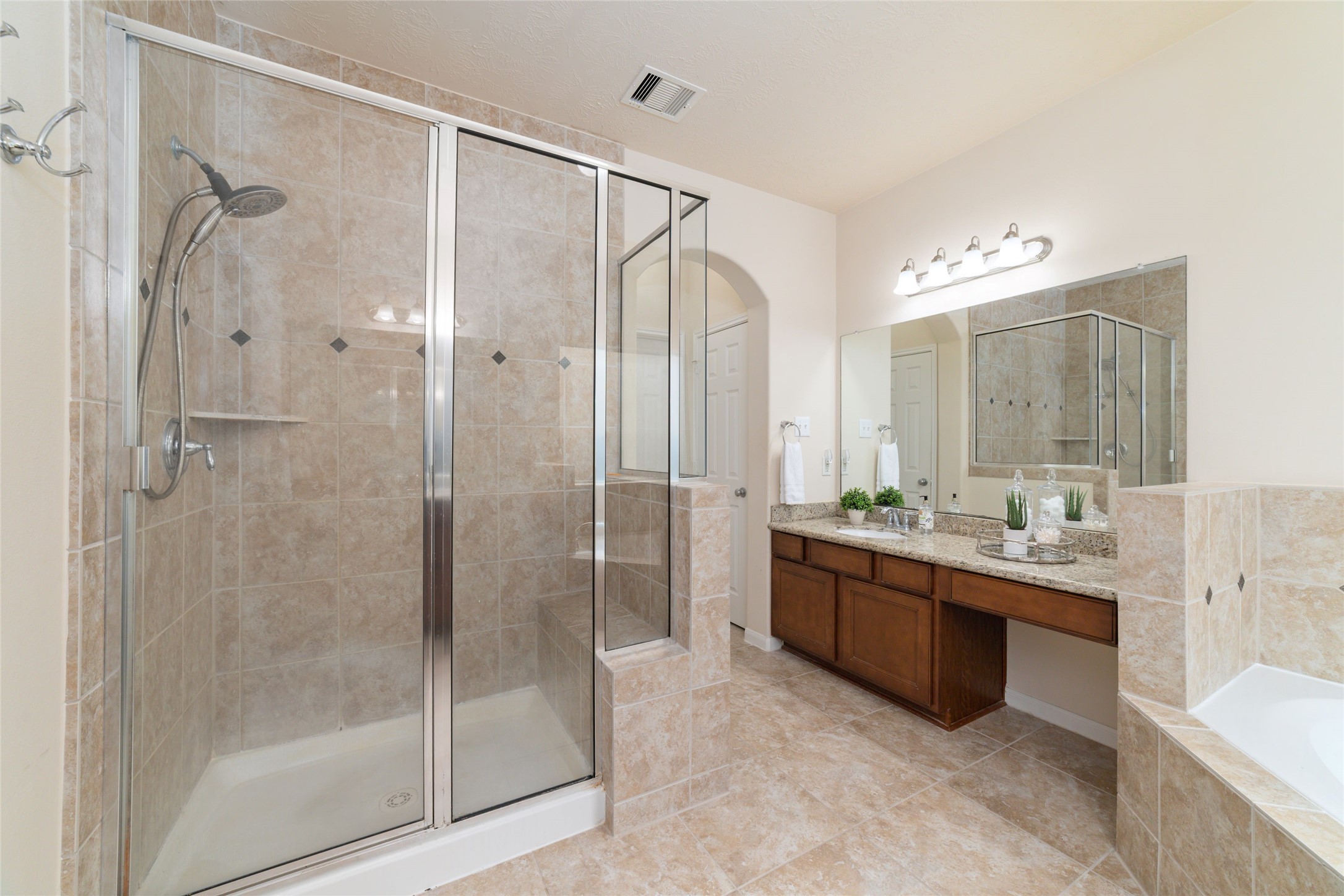 The separate shower features a built in bench.